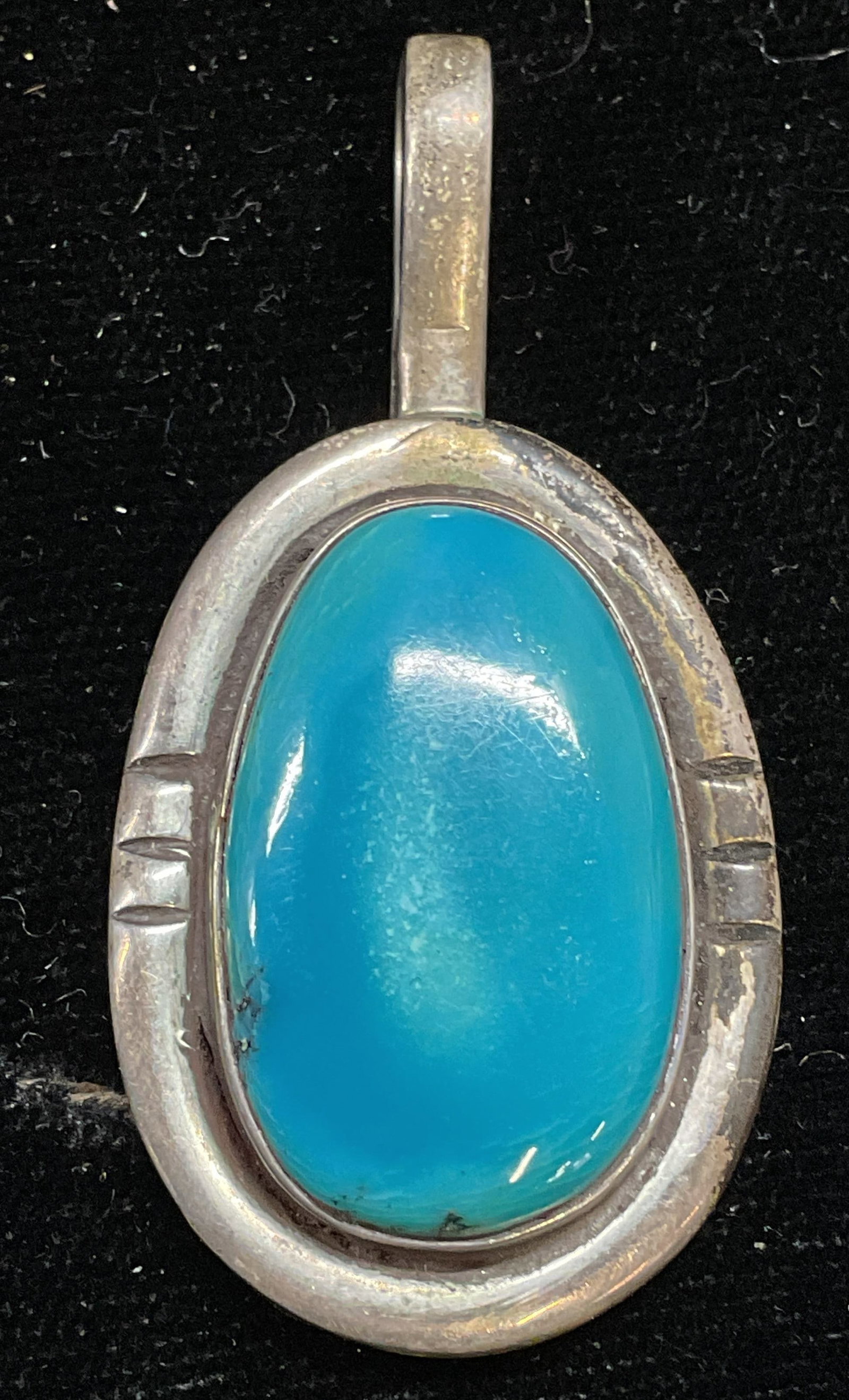 Signed Sterling Silver Turquoise Enamel Pendant: Signed Sterling silver native American style pendant with turquoise blue enamel. Signed on underside, possibly DD. Tests for sterling using acid test. Measures approx 1.25 x 1 inches. Total weight 12.