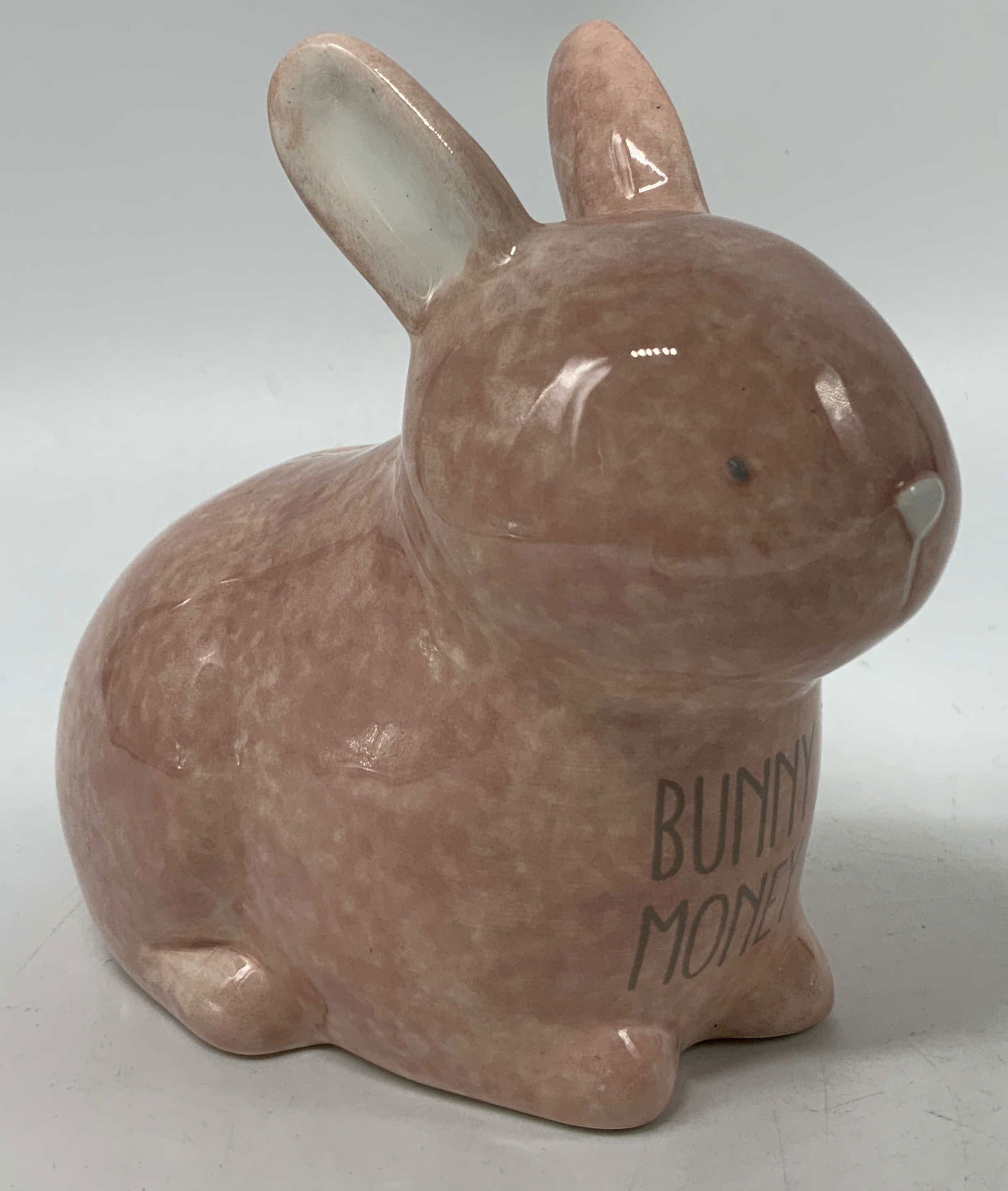 Hand Painted Pink Ceramic Bunny Money Bank: Coin bank is ceramic & is shaped like a pink bunny. Hand-painted details. Body of bunny reads, BUNNY MONEY. No visible signature or markings. Surface wear consistent to age, use & exposure. Measuremen