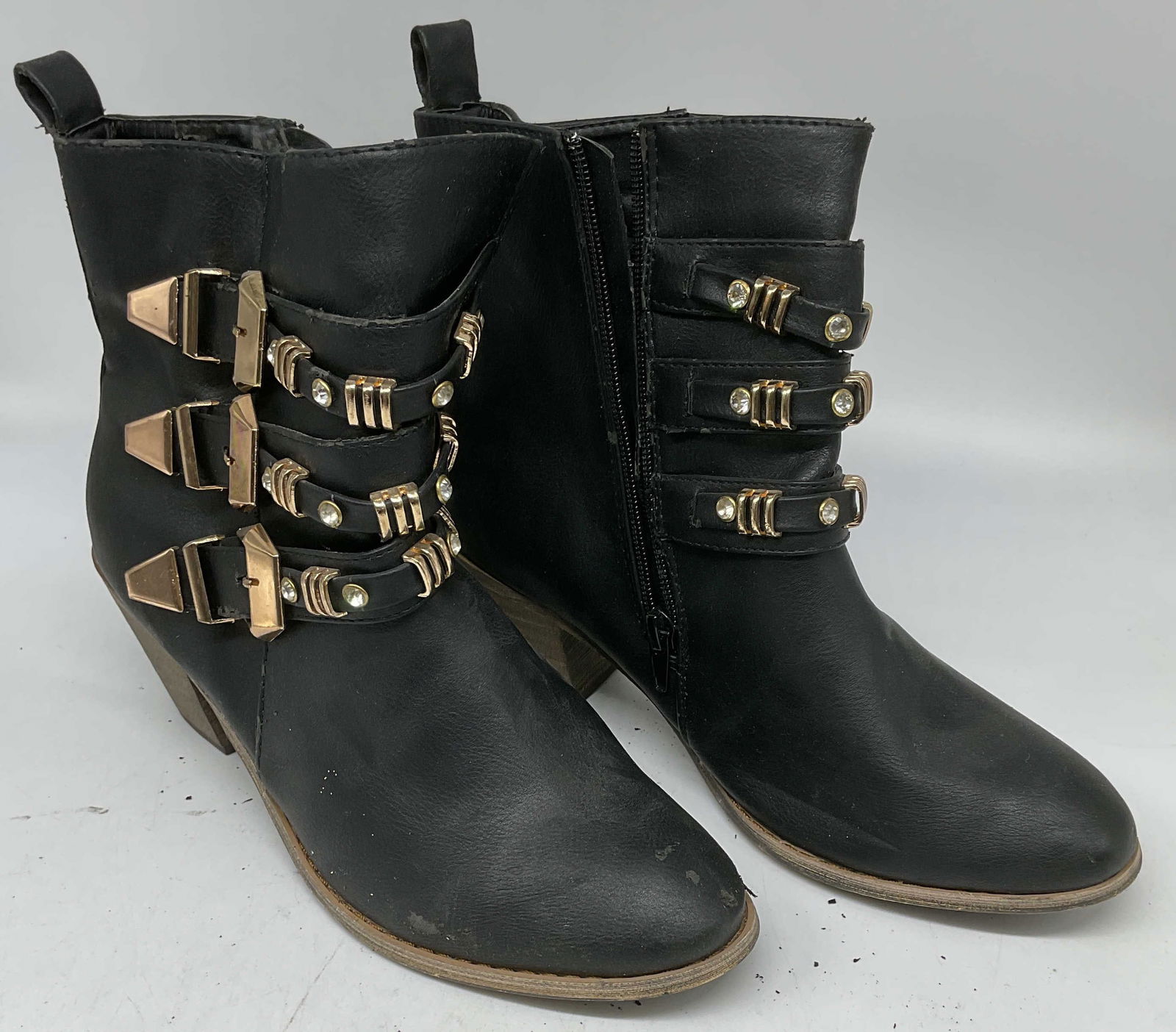 Bucco Black Faux Leather Buckle Heel Boots: Bucco black faux leather high heel boots with gold tone buckle and crystal decoration. Size 7.5. Some scratching and scuffing. Bucco boots, designer boots, black boots, faux leather boots, buckle boot
