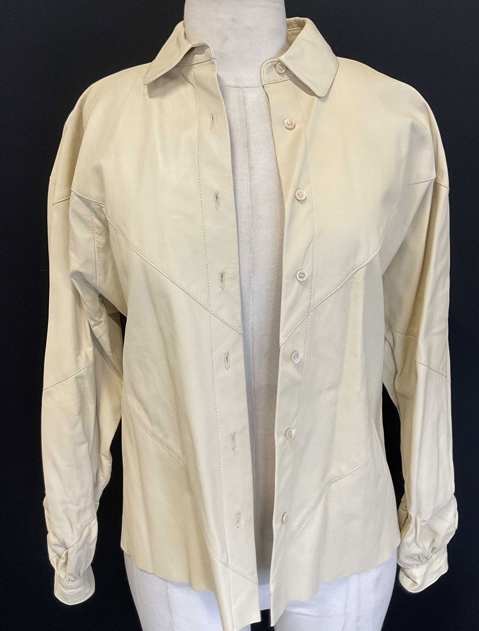 Calvin Klein White Leather Jacket: Calvin Klein white leather jacket. Size 6. Leather material. Collared jacket. Buttons along front. Some wear consistent with exposure. Jacket, coat, leather jacket, white jacket, Calvin Klein jacket,