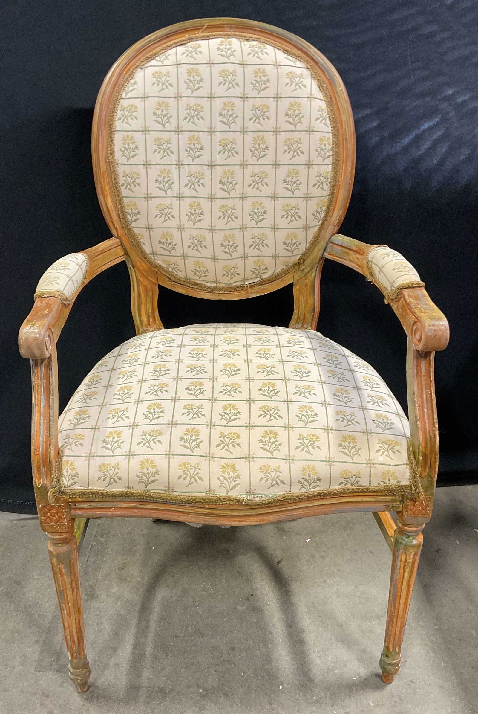 Louis XVI Style Upholstered Medallion Armchair: Vintage Louis XVI style armchair. Decorative wood frame with medallion backrest and upholstered fabric seat and backrest. Floral pattern in white, green and yellow. Measures approx 22 x 19 x 39 inches