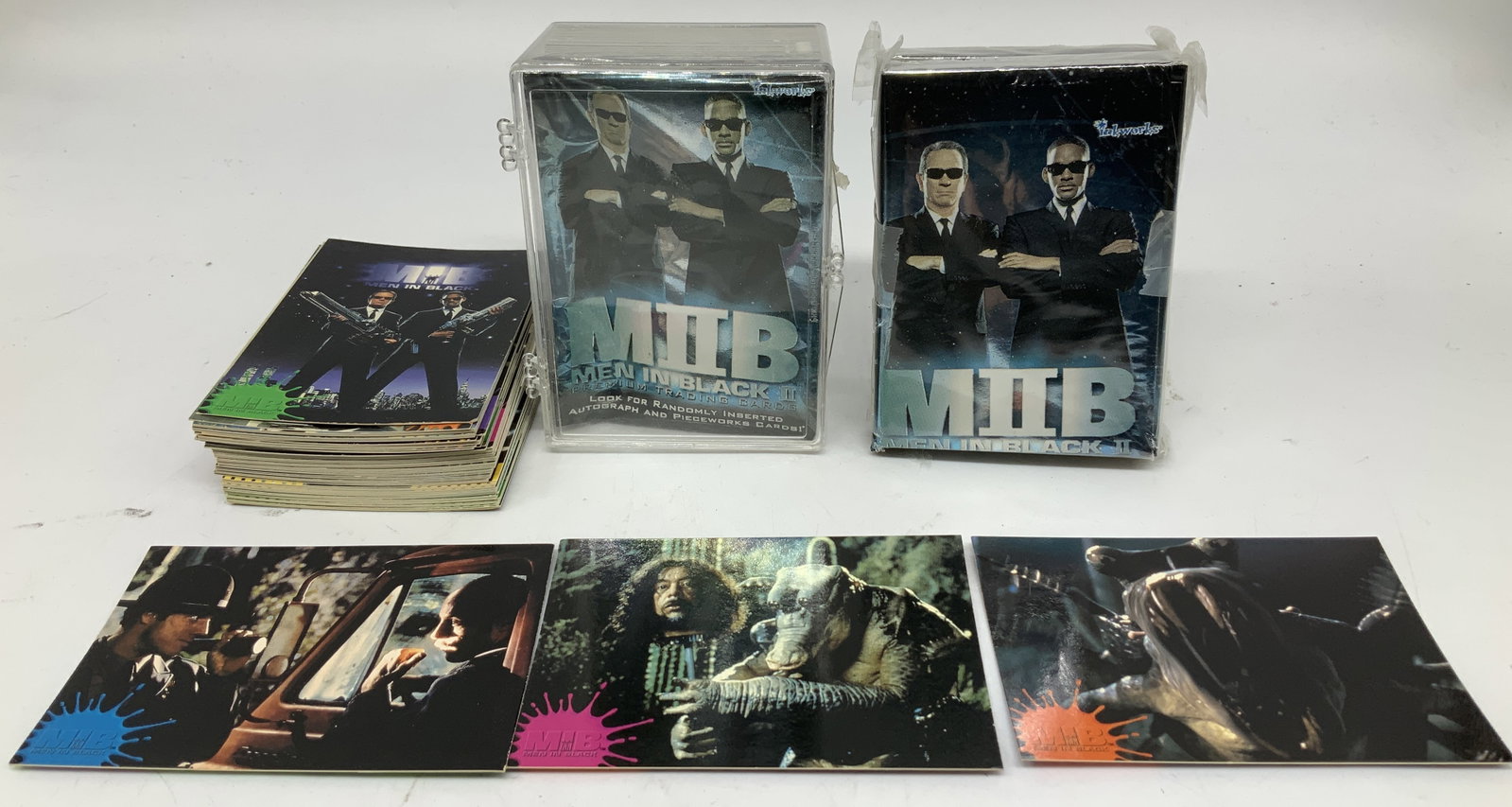 Lot 40+ MIB 1997&2002 Collectible Trading Cards: Lot includes, 40+ MIB & MIB II. (1997 & 2002). Cards feature various characters & scenes. Cards have not been inspected individually. Lot is sold as is. Surface wear consistent to age, use & exposure.