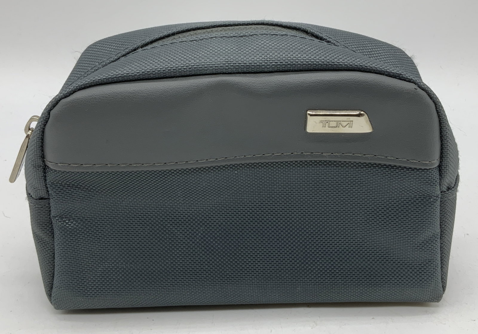 Tumi for Delta Airlines Amenity Pouch: Tumi for Delta Airlines amenity pouch in a grey nylon and synthetic leather material. Signed & marked. Reads, TUMI FOR DELTA. Surface wear consistent to age, use & exposure. Measurements: length 6.5in
