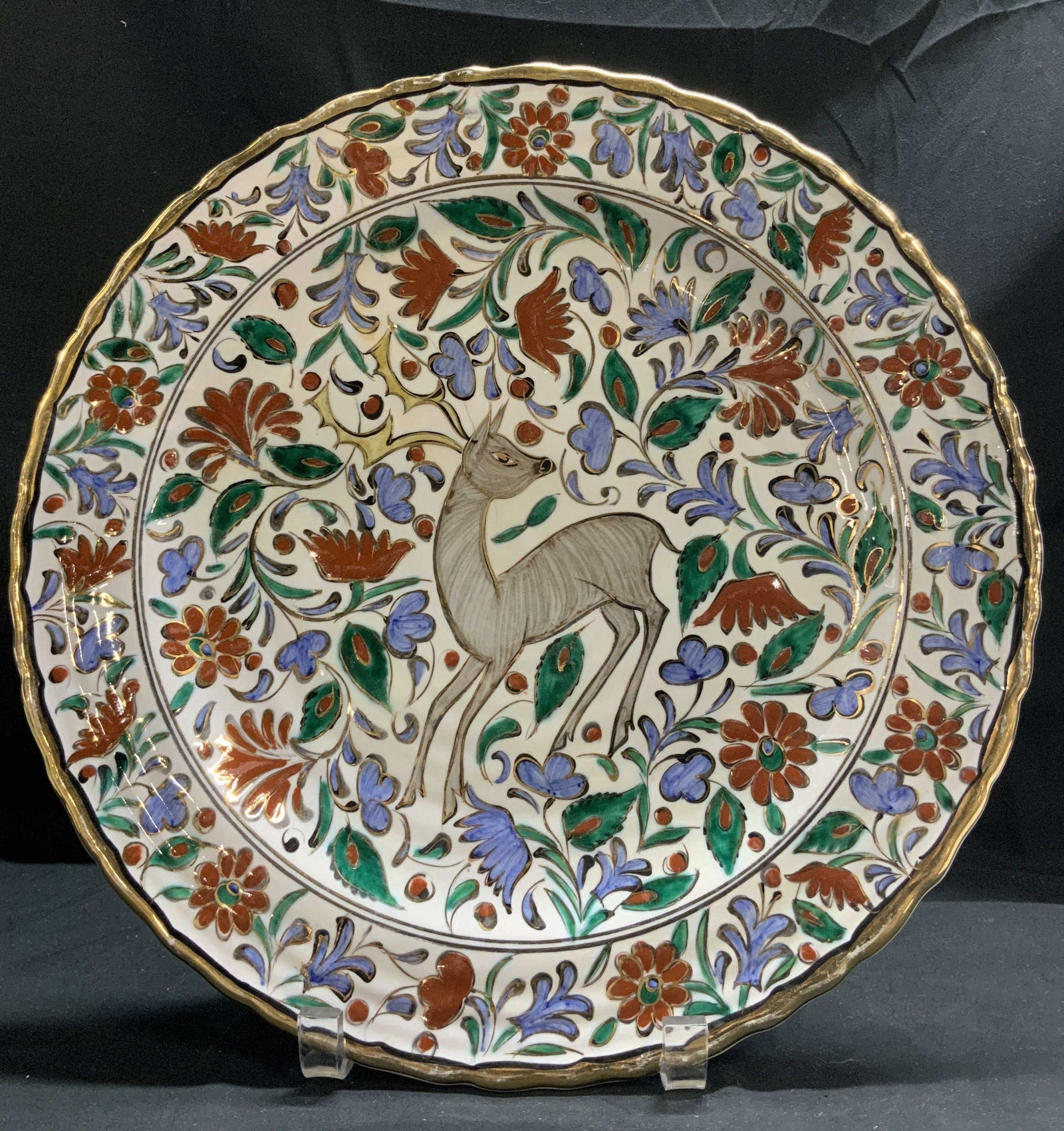 Ikaros Pottery Hand Painted Deco Platter GREECE: Features a central image of a deer surrounded by intricate floral motifs. Shades of white, blue, aqua, green & red. Gilt accents. Signed & marked on underside. Reads, HAND MADE IN RHODES GREECE BY IKA