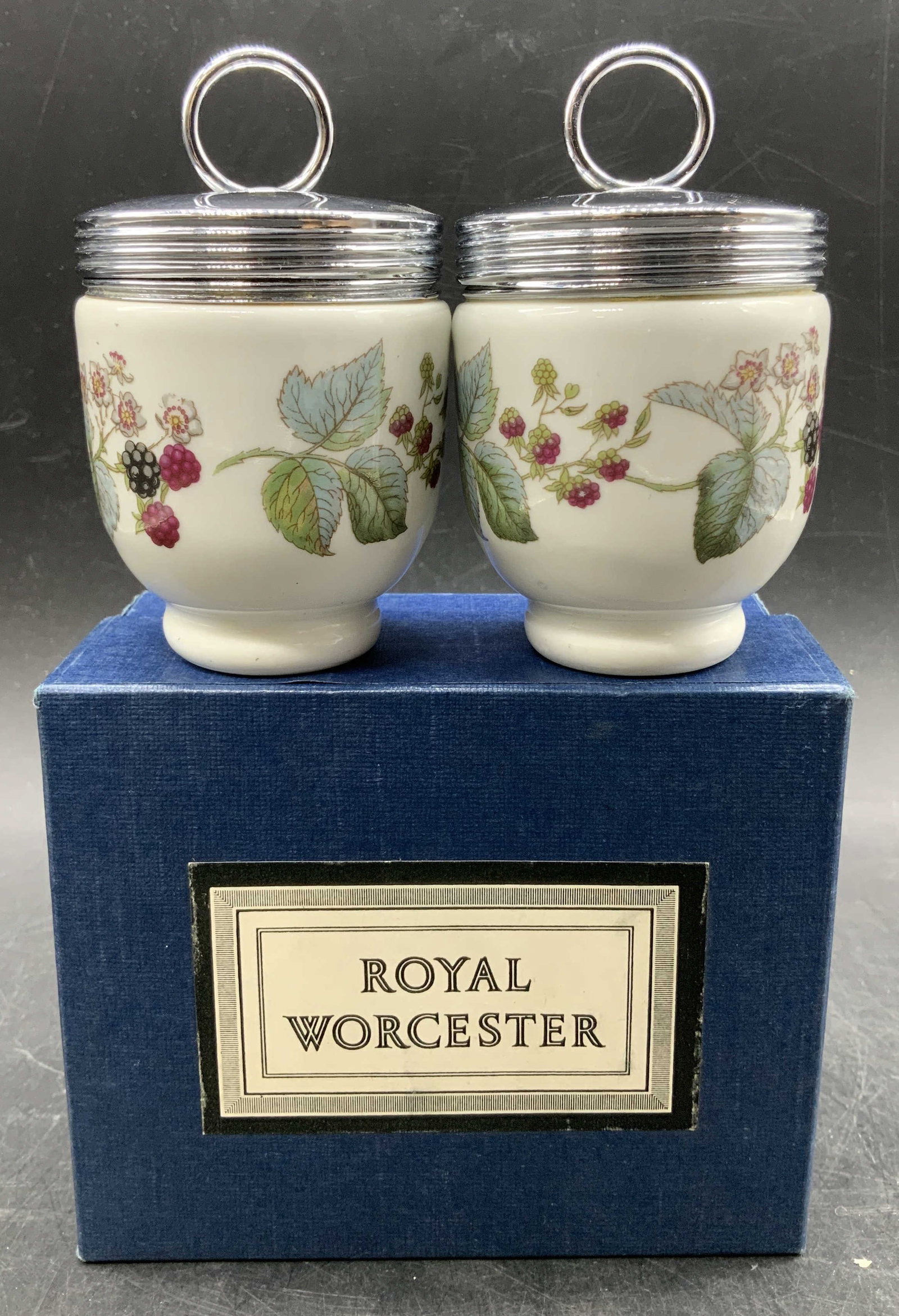 Set 2 Royal Worcester Floral Egg Coddlers ENGLAND: Lot includes, 2 Royal Worcester floral porcelain egg coddlers. Silver toned metal covers. Comes with original box & how to coddle eggs instructions. Signed & marked. Reads, ROYAL WORCESTER. ENGLAND. S