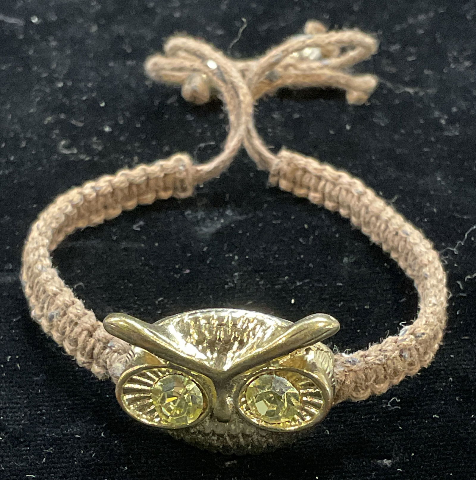 Gold Tone Crystal Owl Pendant Bracelet: Brown braised cord bracelet with gold tone and crystal owl motif pendant. Measures approx 3 inches wide. Some scratching. Jewelry, estate jewelry, costume jewelry, cocktail jewelry, fashion jewelry, a
