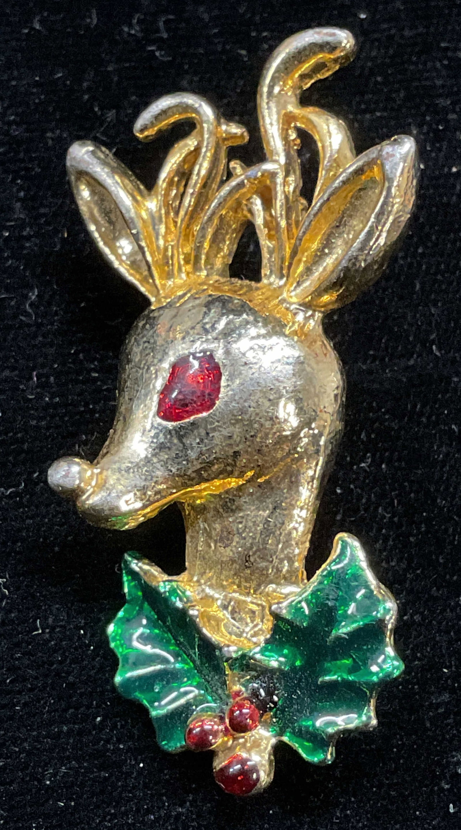 Vintage Gold Tone Reindeer Enamel Brooch: Vintage gold tone reindeer and holly motif enameled brooch. Measures approx 2 x 1 inches. Some scratching. Jewelry, estate jewelry, costume jewelry, cocktail jewelry, fashion jewelry, accessories, fas