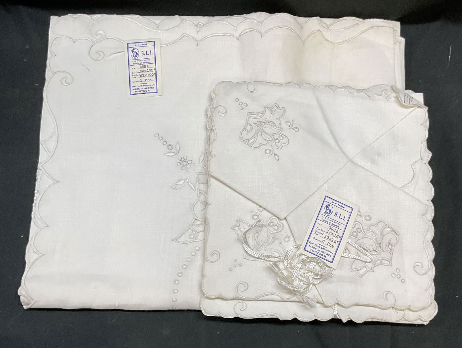 Set7 BLI White Embroidered Table Linens NWT Portug: Set of 7 BLI white embroidered table linens. Tablecloth and napkins. Embroidered designs. New with tags. Tablecloth measures 61 x 100 inches. Napkins measure 15 x 15 inches. Made in Portugal. Some ble