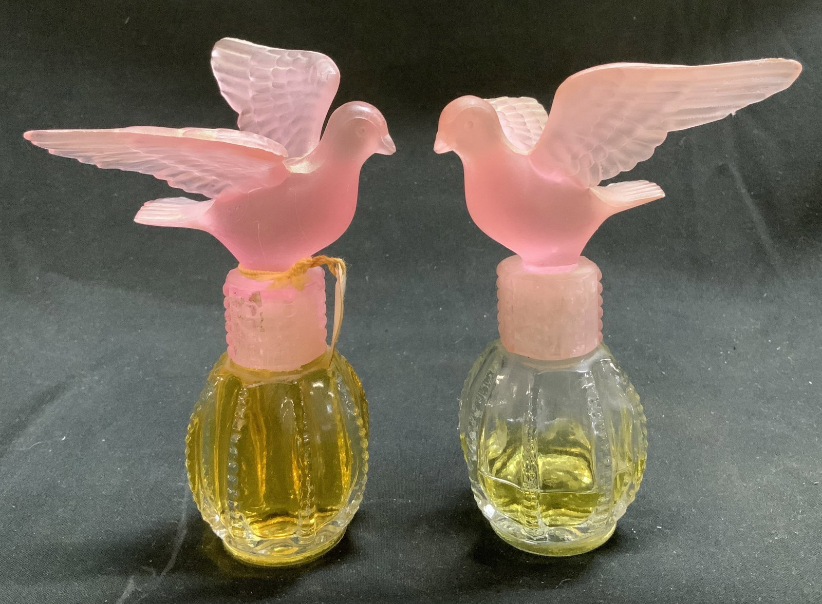 Lot 2 Delagar Royal Dove Perfume Bottle HONGKONG: Vintage Delagar Royal Dove perfume bottle with a pink glass stopper. Stopper is shaped like a dove with outstretched wings. Signed & marked. Reads, DELAGAR ROYAL DOVE. PRINTED IN CANADA. Made in HONG 