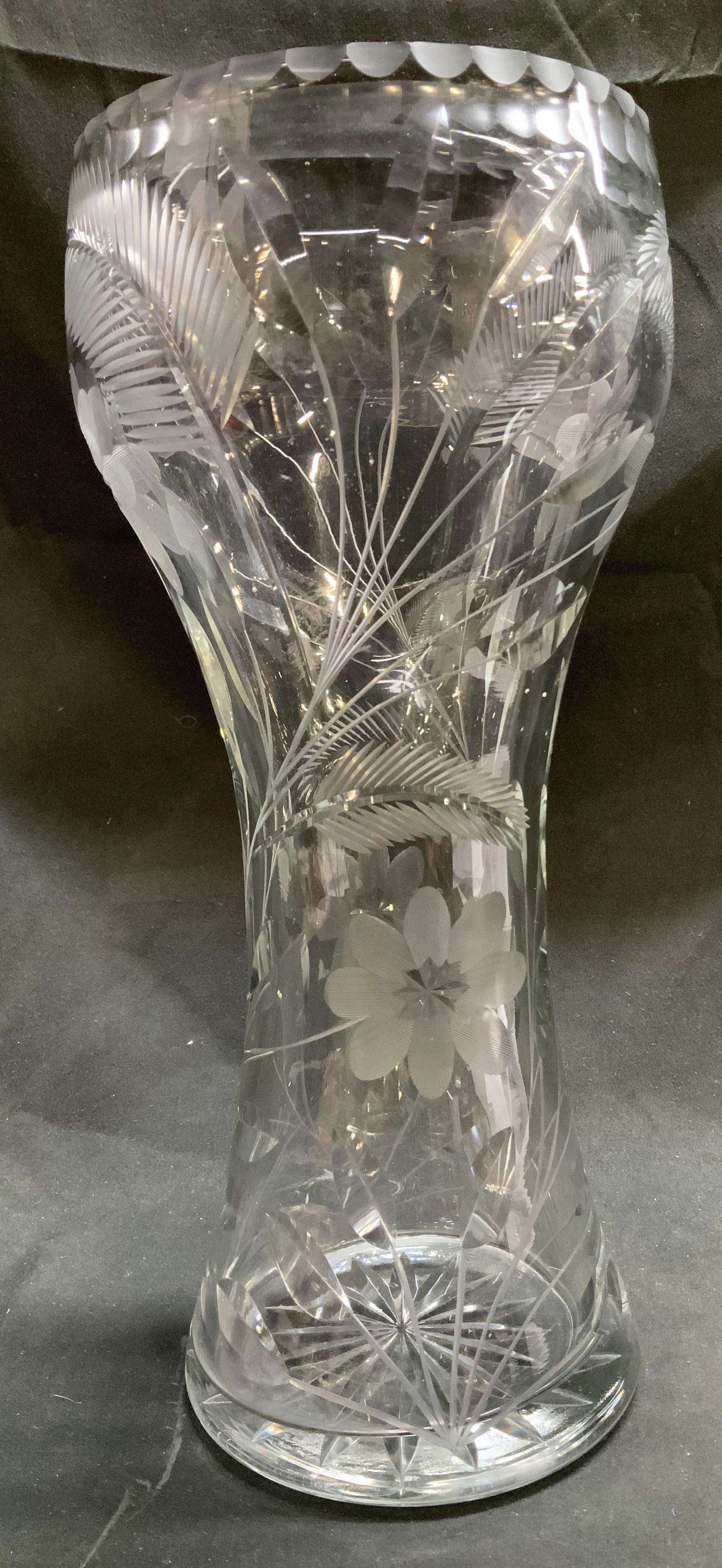 Vtg Clear Cut Glass Floral & Fern Motif Vase: Clear cut glass vase features etched floral & fern motifs throughout body of vase. Star cut base & flared rim. No visible signature or markings. Surface wear consistent to age, use & exposure. Measure