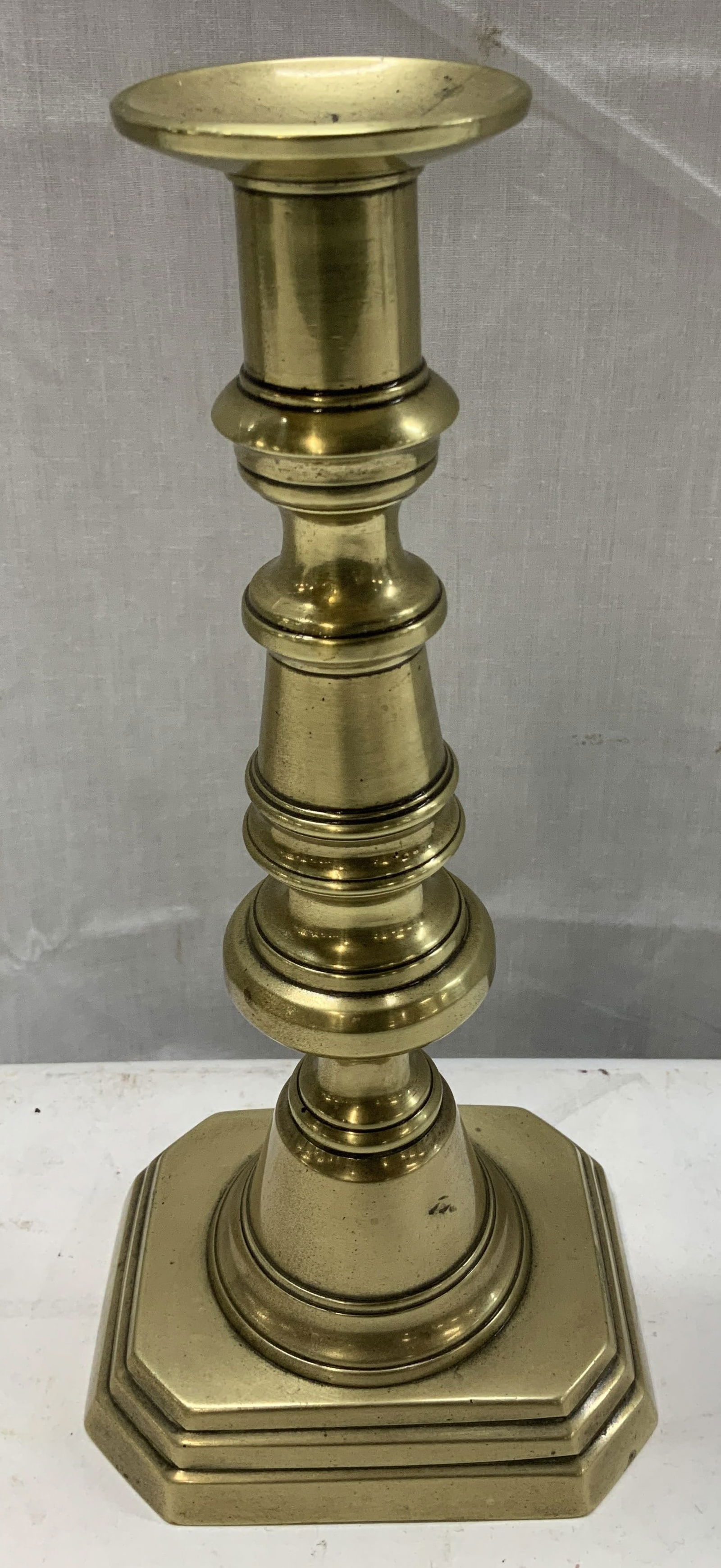 Antq English Brass Push Up Candlestick: Candlestick is brass & features a footed square base w clipped corners. Baluster-shaped stem. Appears to be antique, possible vintage. Surface wear consistent to age, use & exposure. Measurements: len
