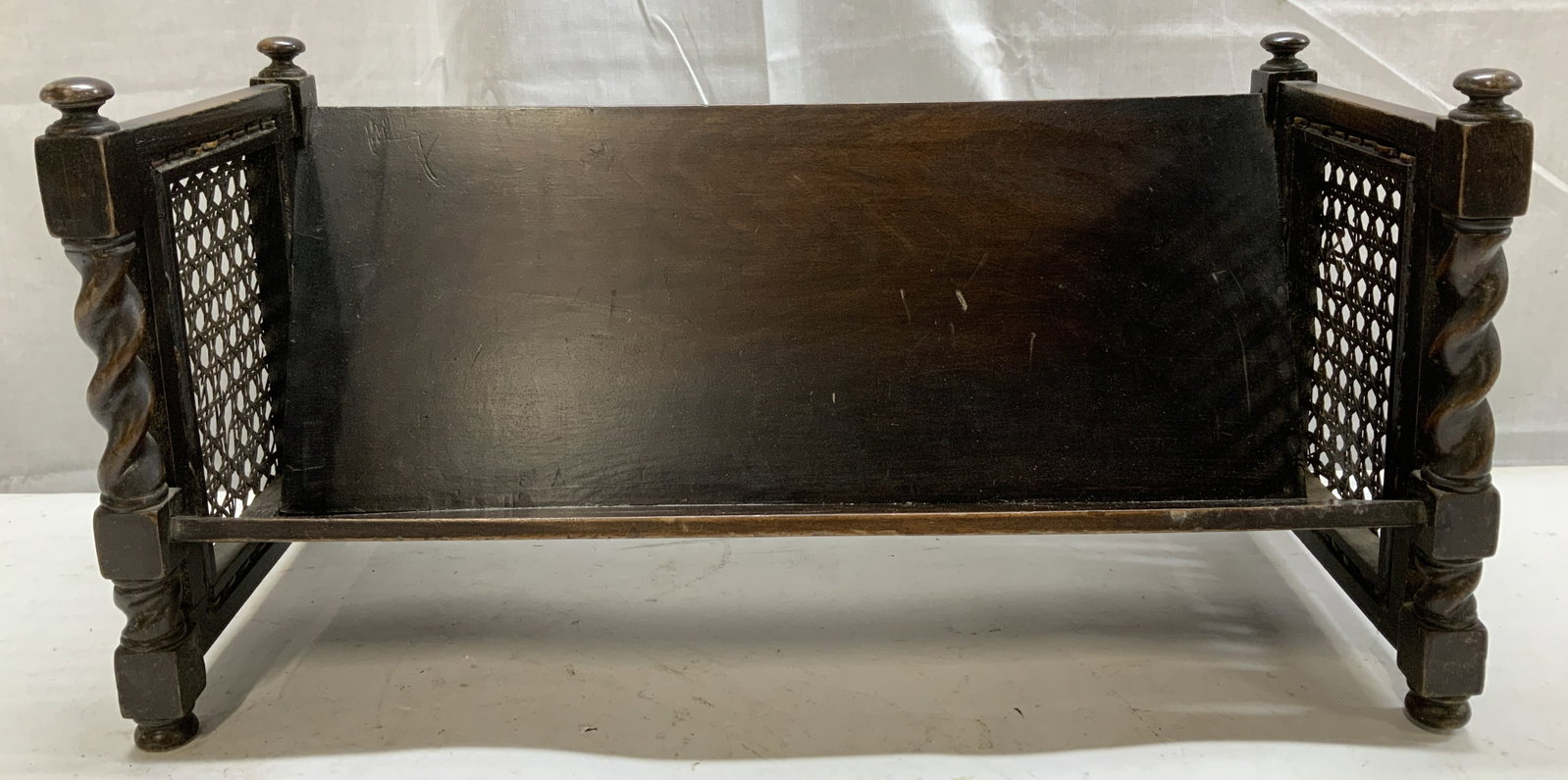 Antique Wooden Book Trough W Twisted Columns: Appears to be antique, possible vintage. Features twist columns & cane webbing style on sides. Dark toned. Surface wear consistent to age, use & exposure. Measurements: length 18.5in x width 8in x hei