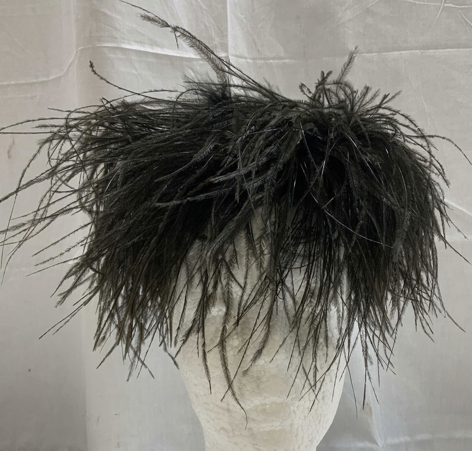 Vtg Black Ostrich Feather Fascinator: Fascinator is black toned & features ostrich feathers. Piece is vintage. No visible signature or markings. Surface wear consistent to age, use & exposure. Measurements: length 5.3in x width 4.7in. Vin