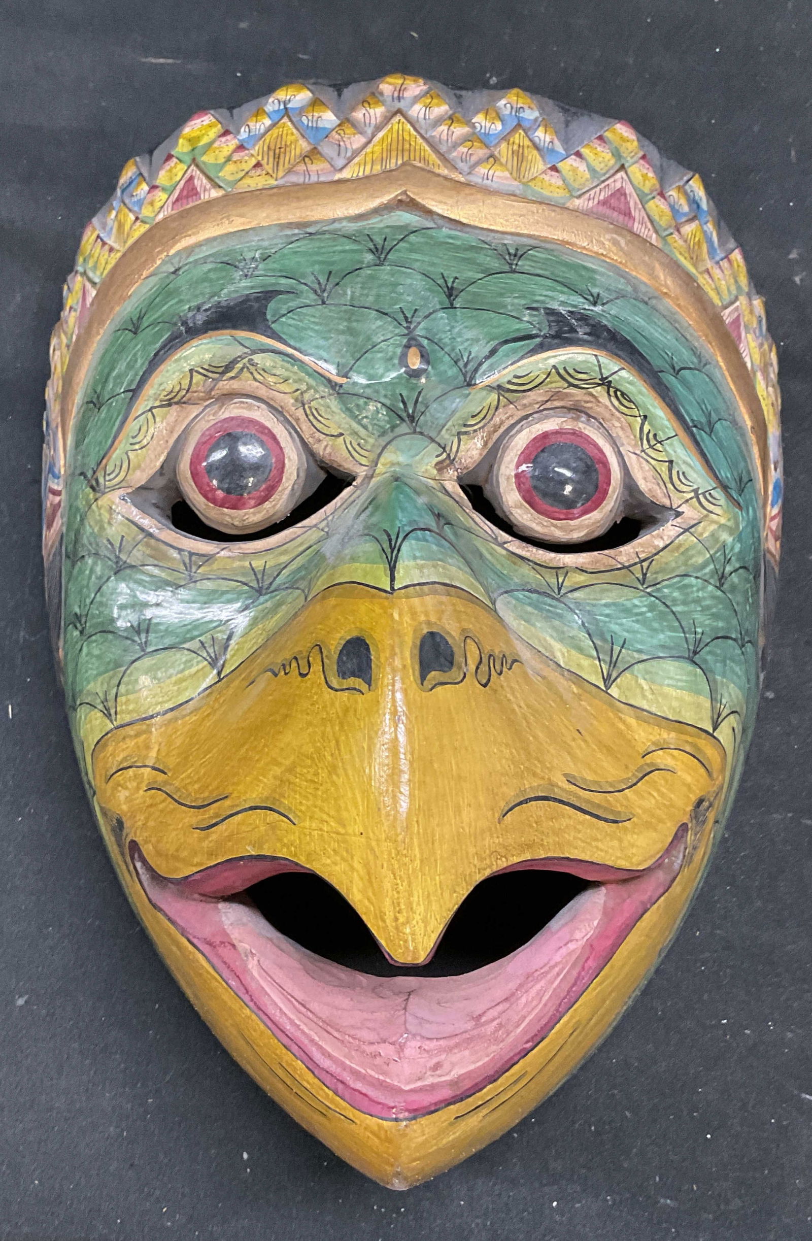 Asian Hand Painted Wood Garuda Mask: Asian carved wood Garuda bird figural mask. Hand painted with ornate decorative detail. Measures approx 8 x 7 x 5 inches. Some wear consistent with exposure. Asian mask, Garuda mask, bird mask, figura