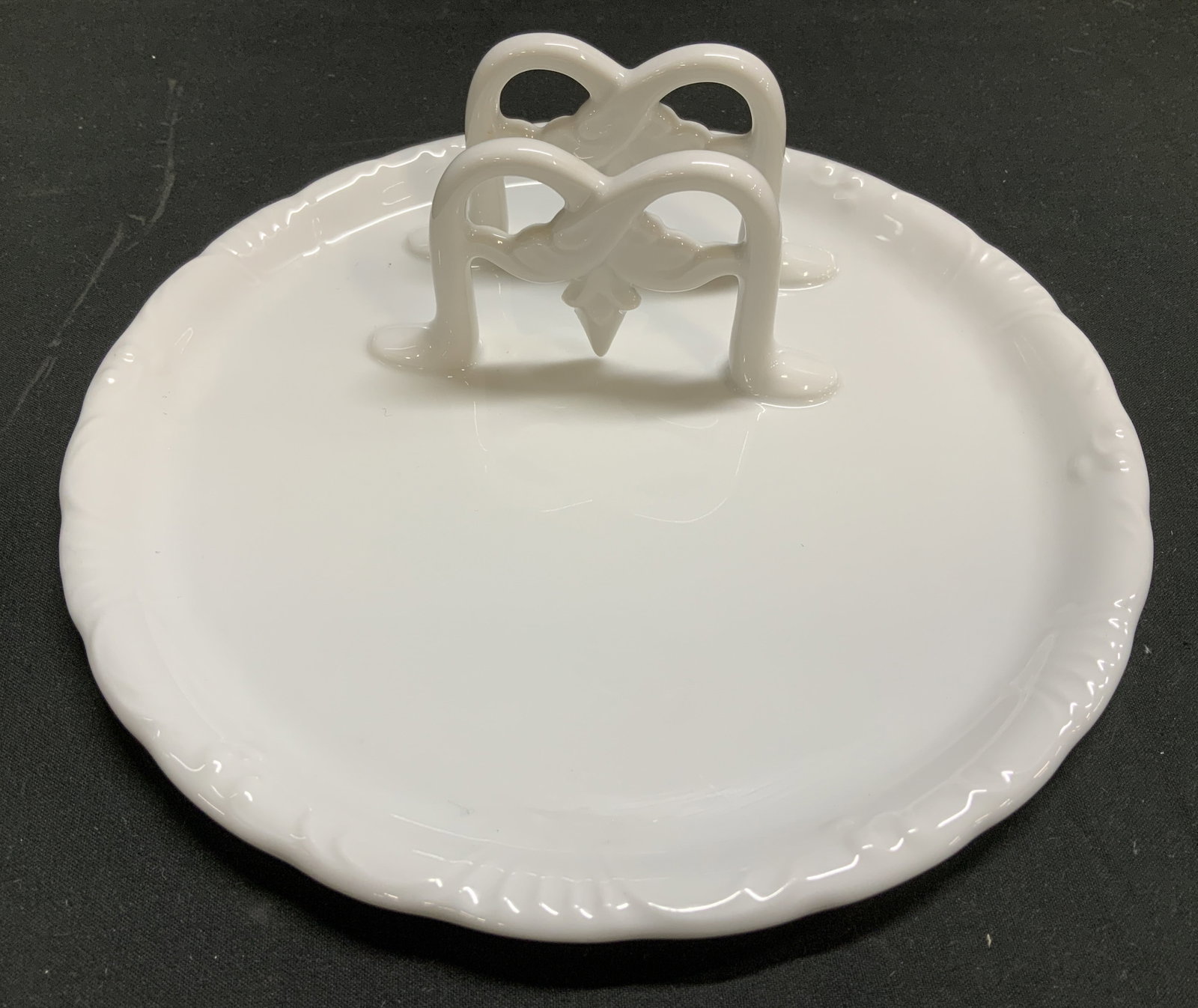 Maryland China Porc Toast Serving Plate JAPAN: Toast serving plate features a decorative, open work toast rack. Piece is porcelain & white toned. Glossy finish. Signed & marked on underside. Reads, MARYLAND CHINA. JAPAN. Surface wear consistent to
