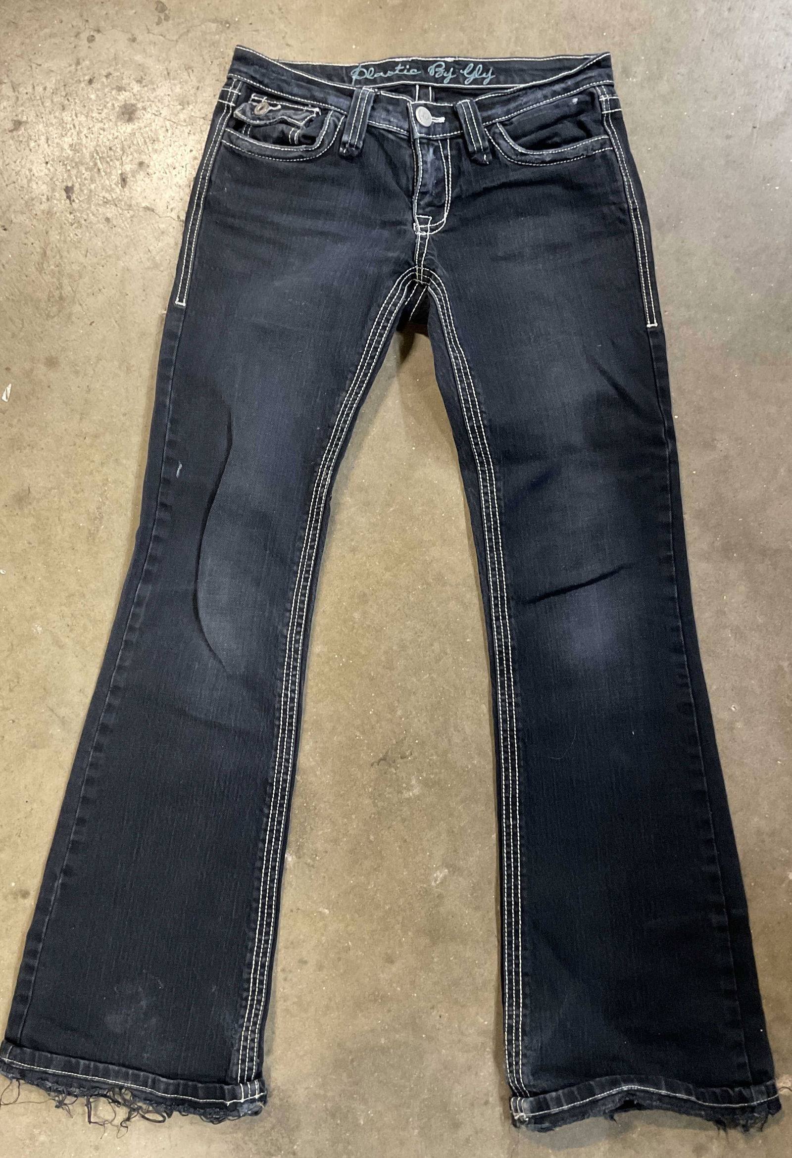 Plastic By Gly Black Jeans USA: Plastic By Gly black jeans. Size 28. Cotton material. Made in USA. White stitching. Flare at bottom. Wear consistent with exposure. Some blemishes observed. Property of 1980s known Rockers Manhattan e
