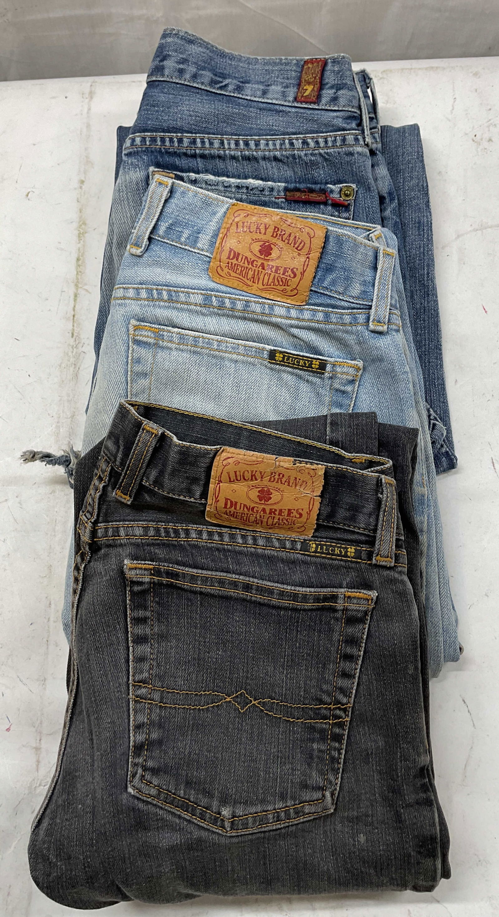 Lot 3 Lucky Brand+ Flare Jeans USA: Lot of 3 pairs of flare jeans. Includes Lucky Brand black flare jeans, size 4, cotton material, made in USA. Lucky Brand light wash flare jeans, size 4, cotton material, made in USA. 7 For All Mankind