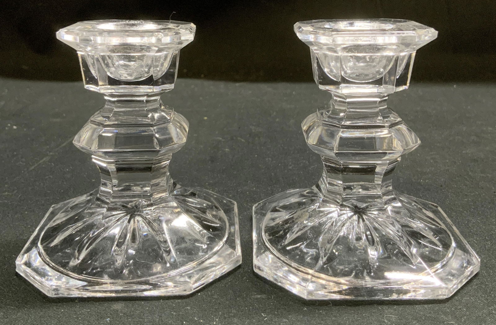 Vtg Pair Faceted Clear Glass Candle Holders: Pair of vintage clear glass candle holders featuring a faceted stem & an octagonal base. Flared cup. Surface wear consistent to age, use & exposure. Measurements: length 2.7in x width 2.7in x height 3