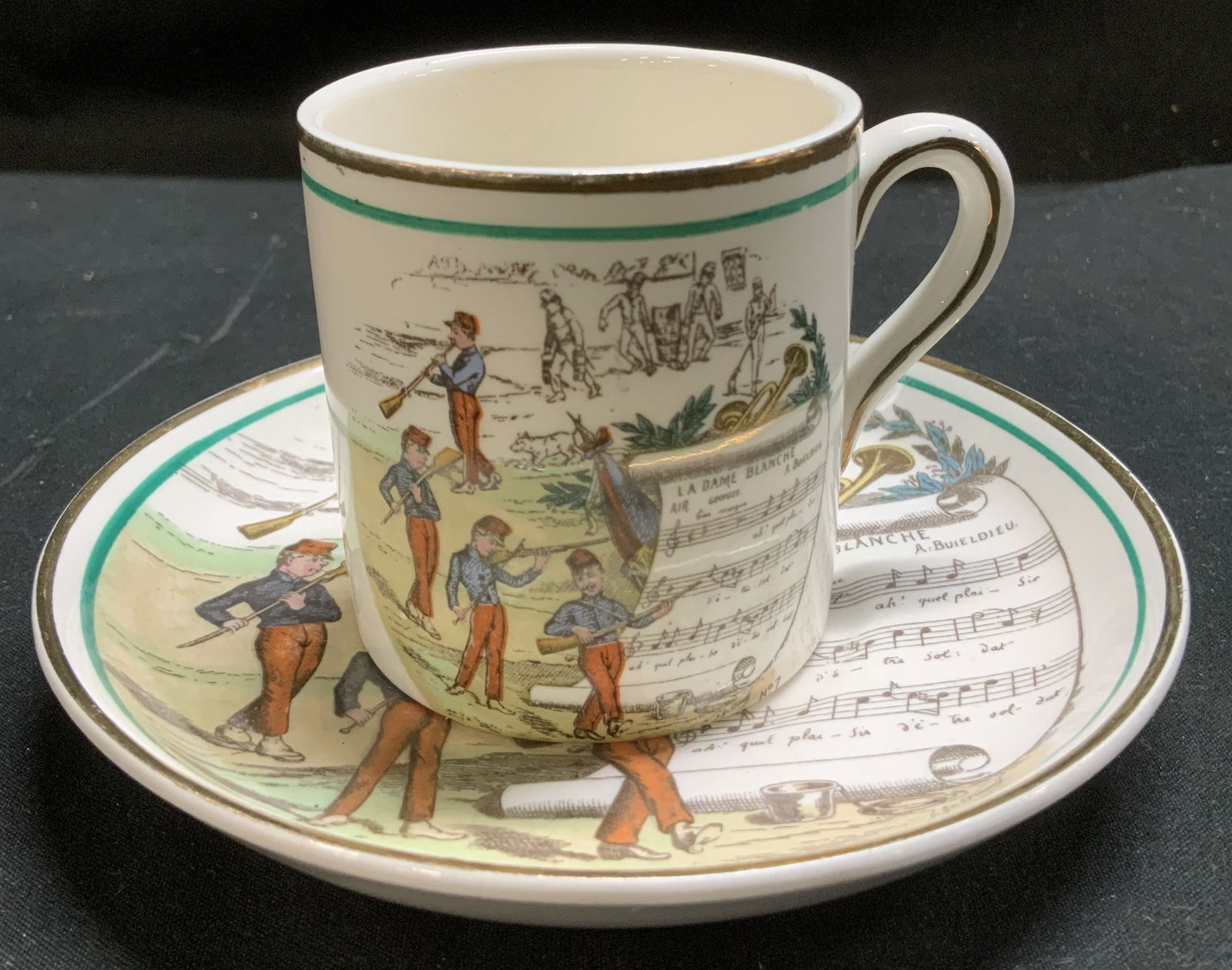 Vtg Parry Vielle La Dame Blanche Teacup&Saucer Eng: Vintage porcelain teacup & saucer featuring a scene from the opera La Dame Blanche. Sheet of music & dancing figures. Features gilt accents on rim & handle. Signed & marked on underside. Reads, MADE I
