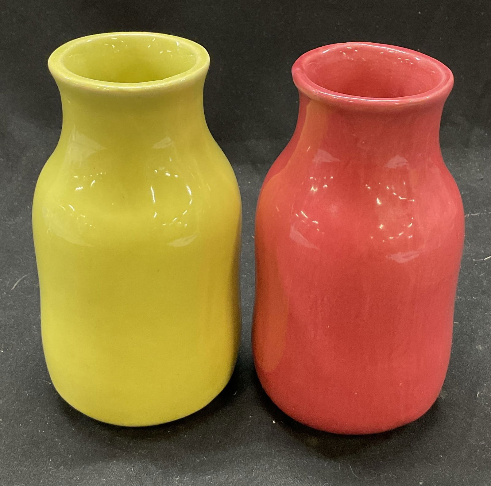 Lot 2 SGND B. Eigan Red & Yellow Ceramic Vases USA: Lot of 2 signed B. Eigan hand painted red and yellow ceramic vases. Made in USA. Signed on underside, reads as follows B. Eigan U.S.A. Flared narrow neck and flat round body. Hand painted in yellow an