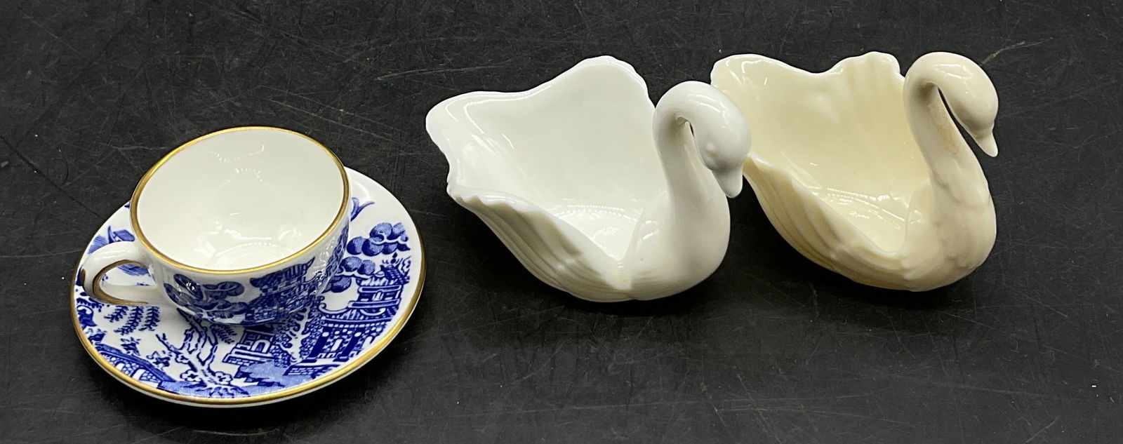 Lot 4 Lenox & Coalport Miniatures England: Lot of 4 porcelain miniatures. Includes two Lenox white porcelain swan miniatures. Marked on underside, reads as follows Lenox. Textured features. Measures approx 2 1/2 x 1 1/2 x 2 inches. Coalport wh