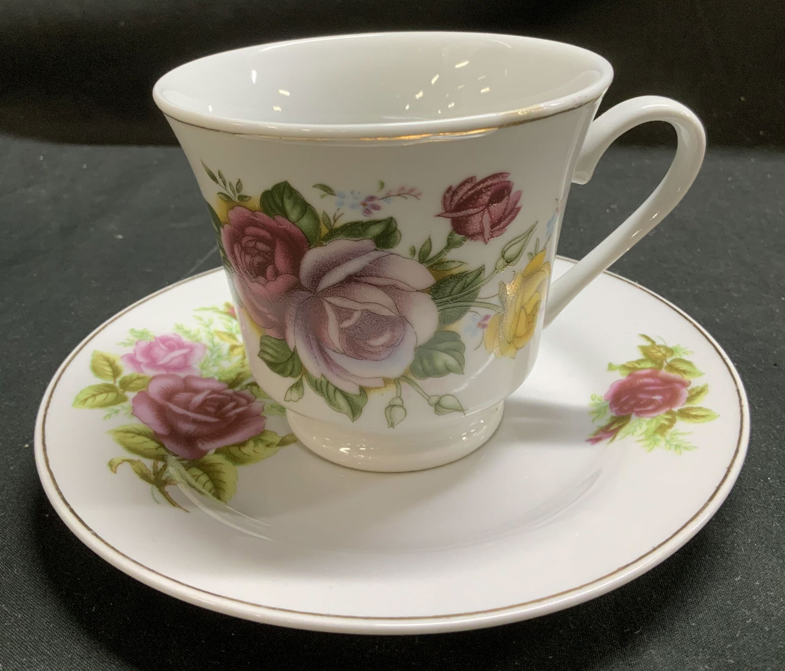 Vntg Pink Floral Porcelain Teacup & Saucer: Lot includes, 1 teacup & 1 saucer. Pieces are porcelain & feature hand decorated pink floral motifs. Shades of pink, yellow & green. Gilt accents. Signed & marked on underside. Reads, MADE IN CHINA. S