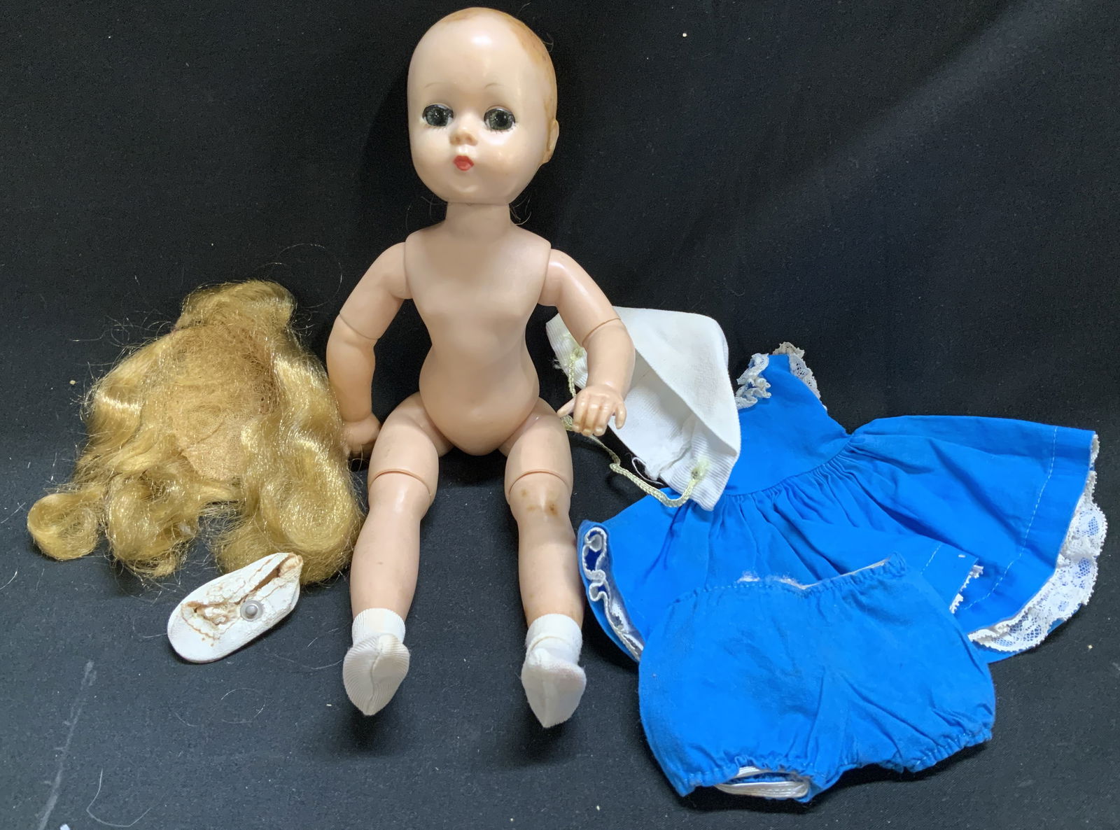 Vntg Blonde Baby Doll W Blue Laced Dress: Lot includes, 1 vintage girl doll with jointed limbs & blonde hair. Comes with blue doll dress w lace trim, blue undergarment & shoes. No visible signature or markings. Surface wear consistent to age,
