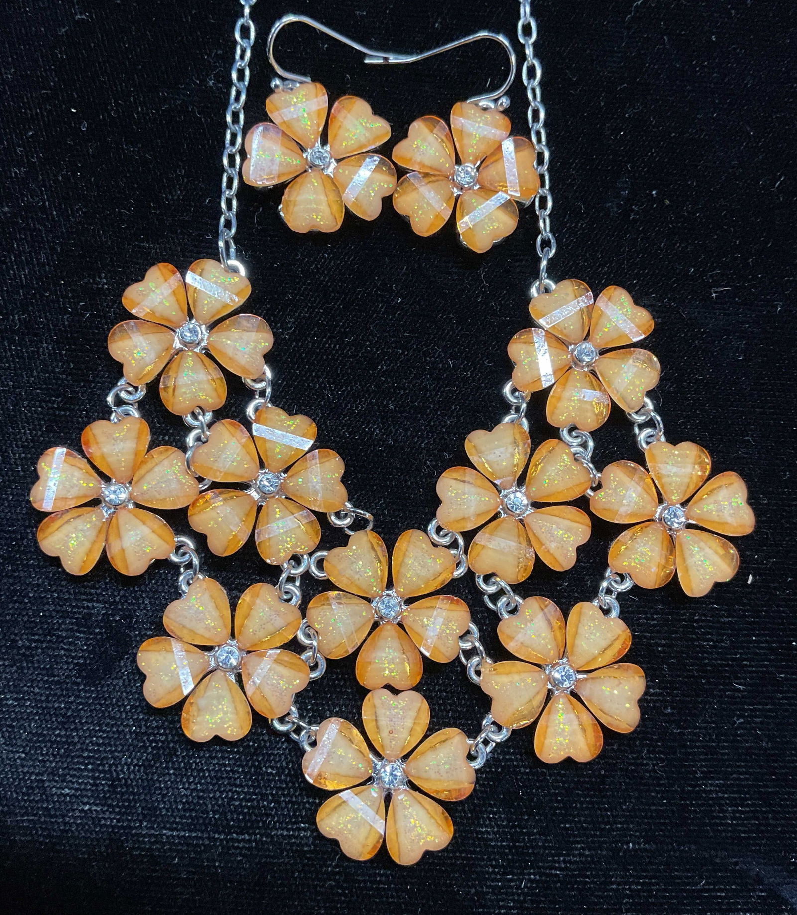 Lot 2 Orange Lucite Flower Necklace & Earrings: Lot of 2 matching jewelry pieces. Silver tone flower necklace with orange lucite and colorless crystals and matching flower earrings. Necklace drop length approx 9.5 inches. Earrings approx .75 inches