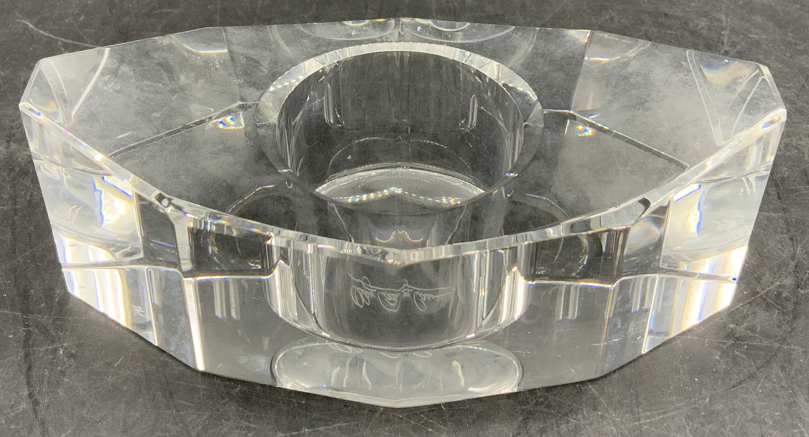 Oleg Cassini Crystal Votive Candle Holder: Oleg Cassini crystal votive candle holder. Piece has a multi faceted design. Signed & marked on underside. Reads, Oleg Cassini. Surface wear consistent to age, use & exposure. Measurements: length 4.8