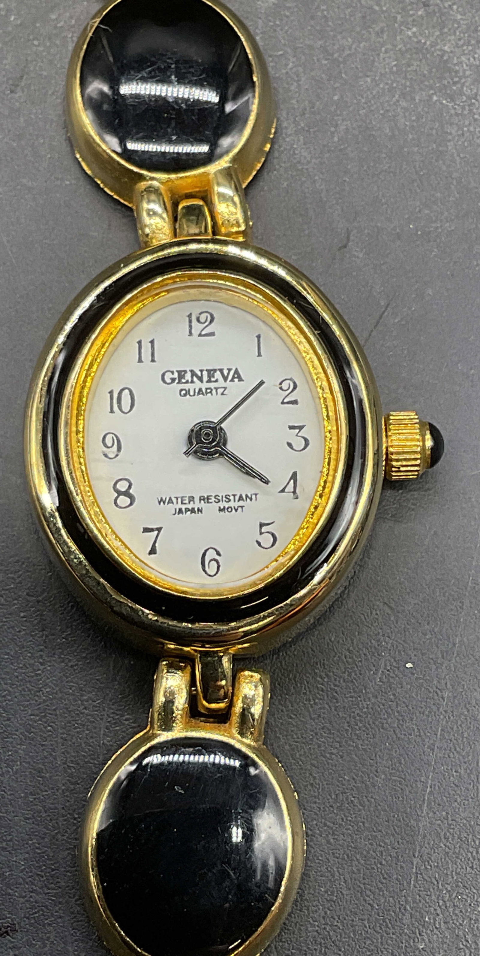 Geneva Gold Tone Black Enamel Wristwatch: Signed Geneva gold tone and black enamel wristwatch. Measures approx 6.75 inches long. Not tested. Some scratching. Jewelry, estate jewelry, costume jewelry, cocktail jewelry, fashion jewelry, accesso