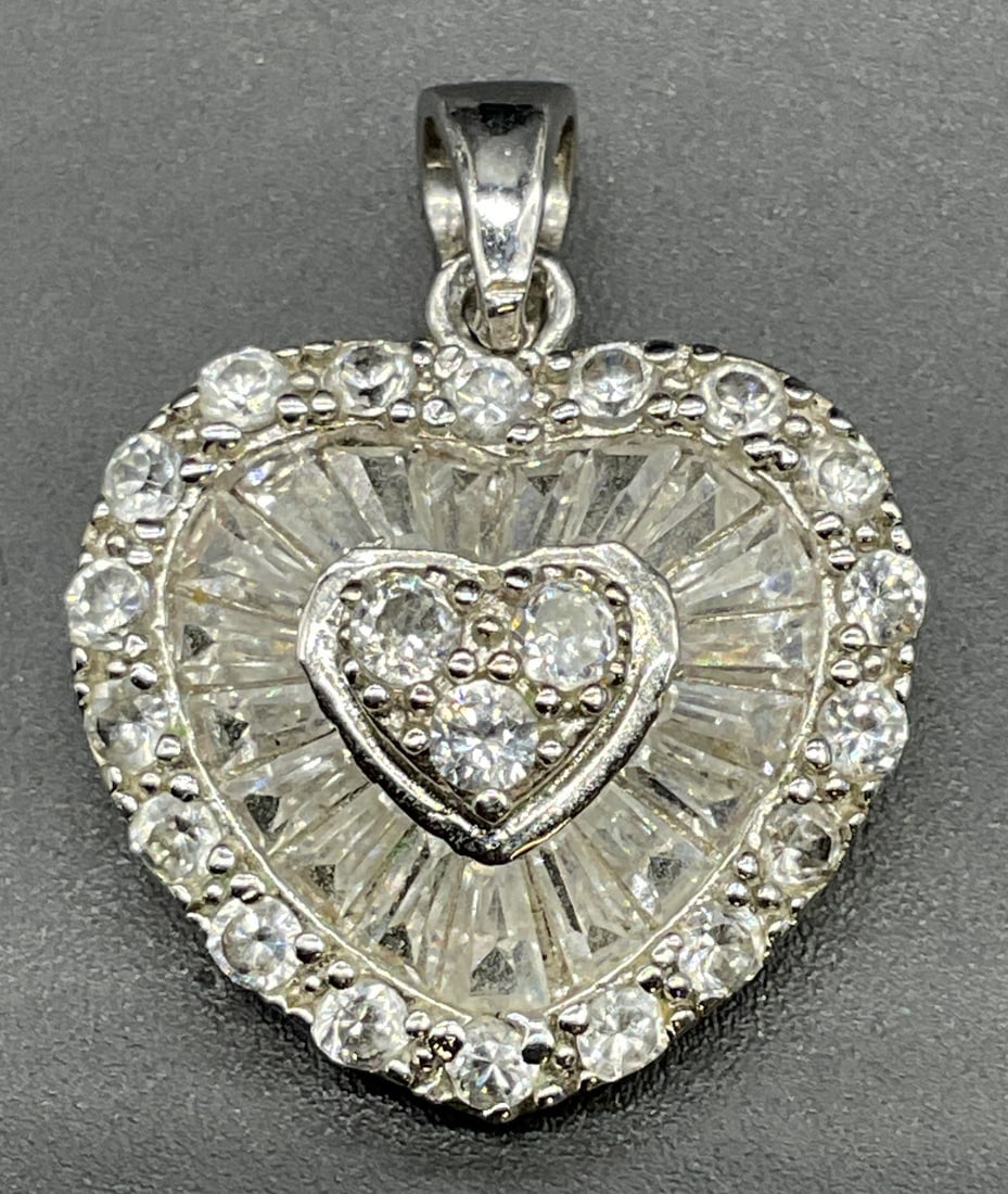 Sterling Silver Crystal Heart Pendant: Sterling silver colorless crystal heart pendant. Measures approx .75 x .75 inches. Total weight 3.1 grams. Some scratching. Jewelry, estate jewelry, fine jewelry, cocktail jewelry, fashion jewelry, ac