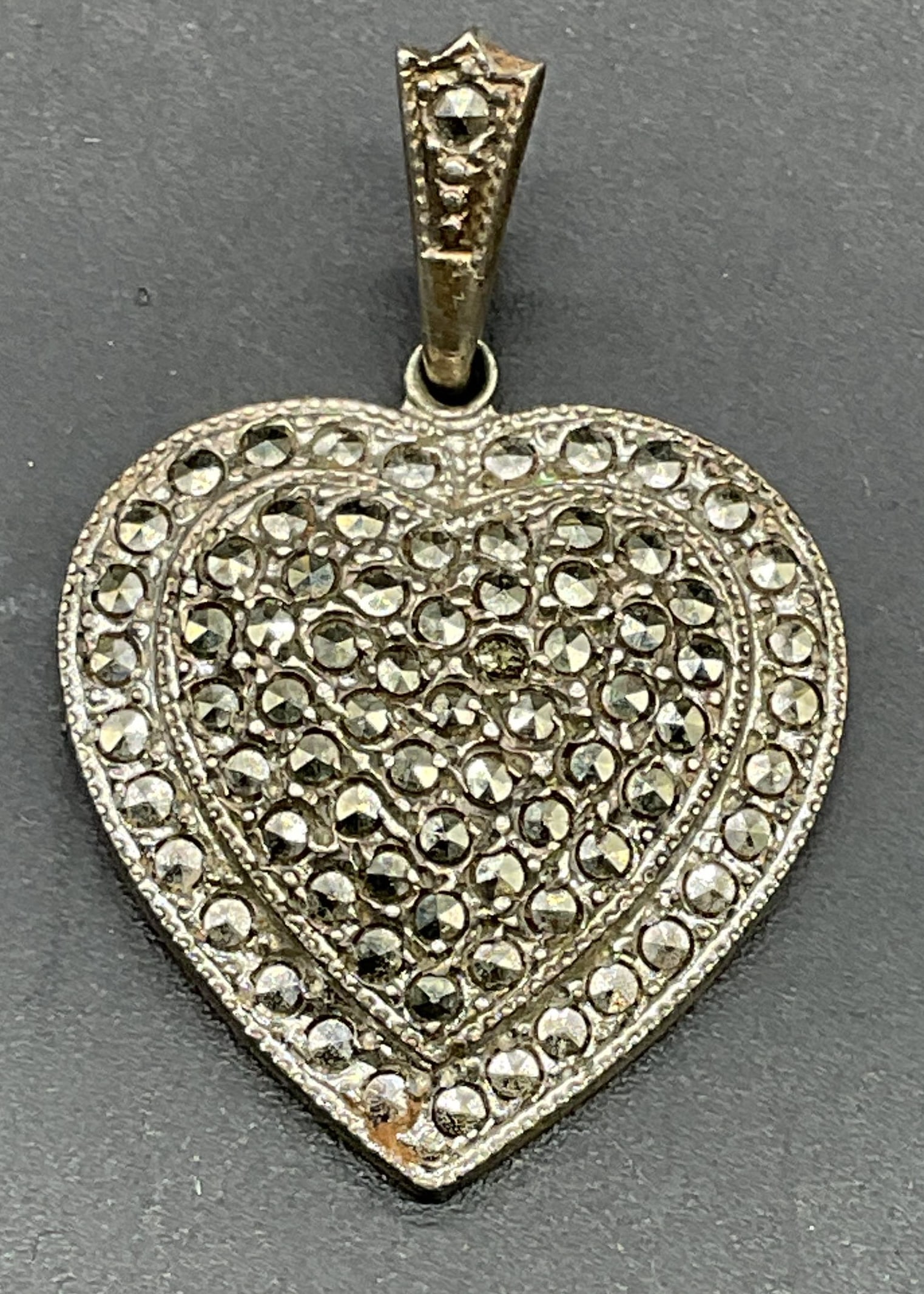 Theda Sterling Silver Marcasite Heart Pendant: Signed Theda Sterling silver and marcasite heart pendant. Measures approx .75 x .75 inches. Total weight 4.2 grams. Some scratching. Jewelry, estate jewelry, fine jewelry, cocktail jewelry, fashion je
