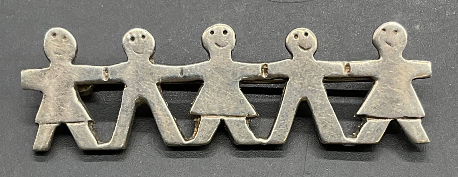 Vintage Sterling Silver Figural Brooch, Mexico: Vintage sterling silver brooch with smiling figural motif. Made in Mexico, marked sterling. Measures approx .5 x 2 inches. Total weight 7.6 grams. Some scratching. Jewelry, estate jewelry, fine jewelr