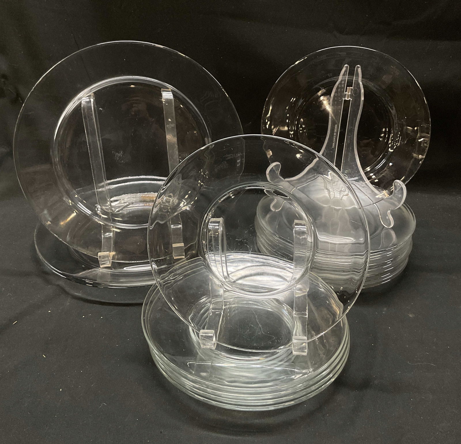 Set 21 Vintage Glass Plates: Set of 21 vintage glass plates. Includes 3 dinner plates, 5 luncheon plates, and 13 salad plates. Largest plate measures approx 10 inches wide. Rim chip and scratching observed. Surface wear consisten