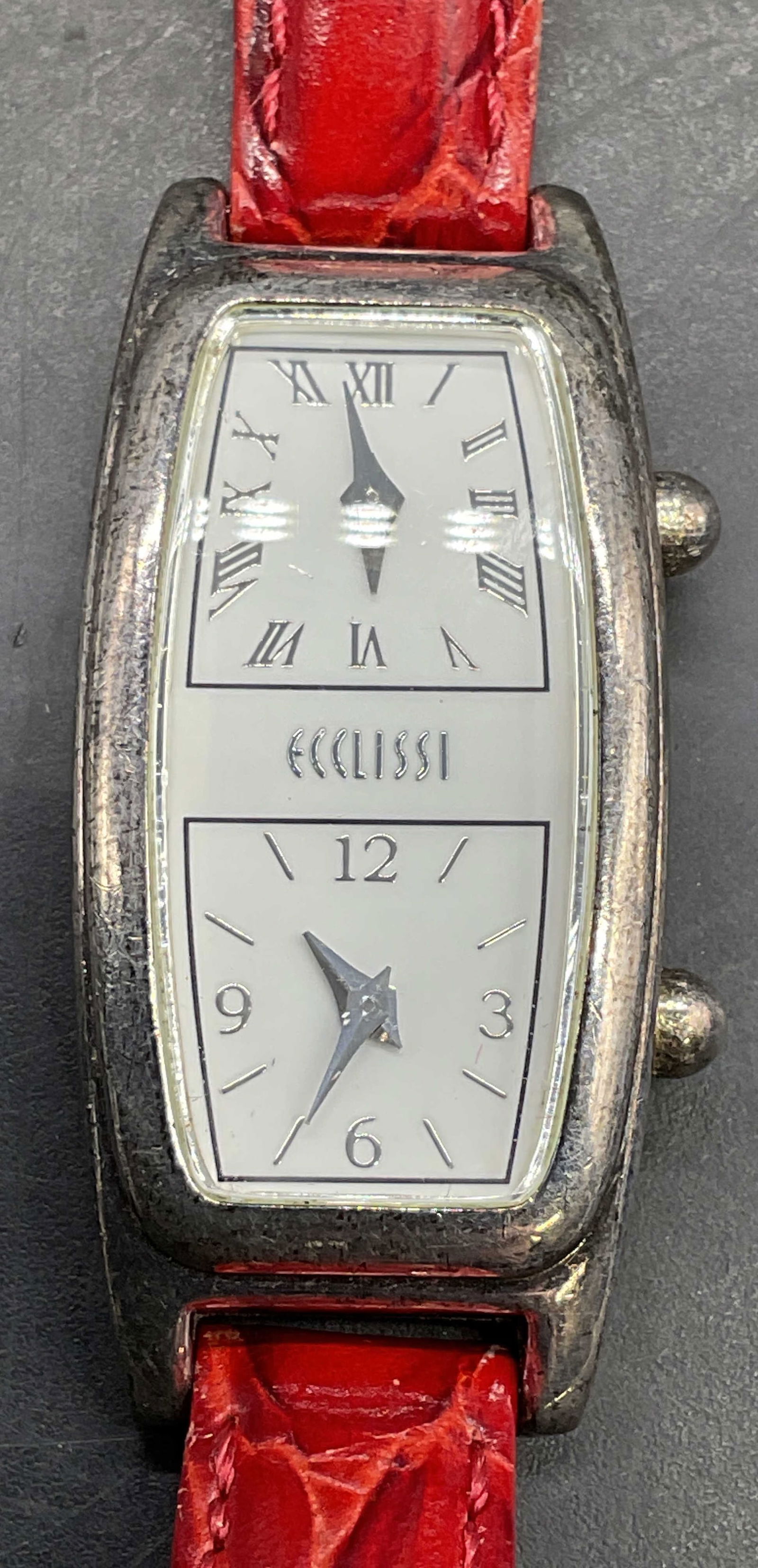 Ecclissi Sterling Silver Red Leather Wristwatch: Signed Ecclissi double face wristwatch with red croc motif leather strap. Sterling silver case, stainless steel back. Measures approx 8 inches long. Not tested. Some scratching. Jewelry, estate jewelr