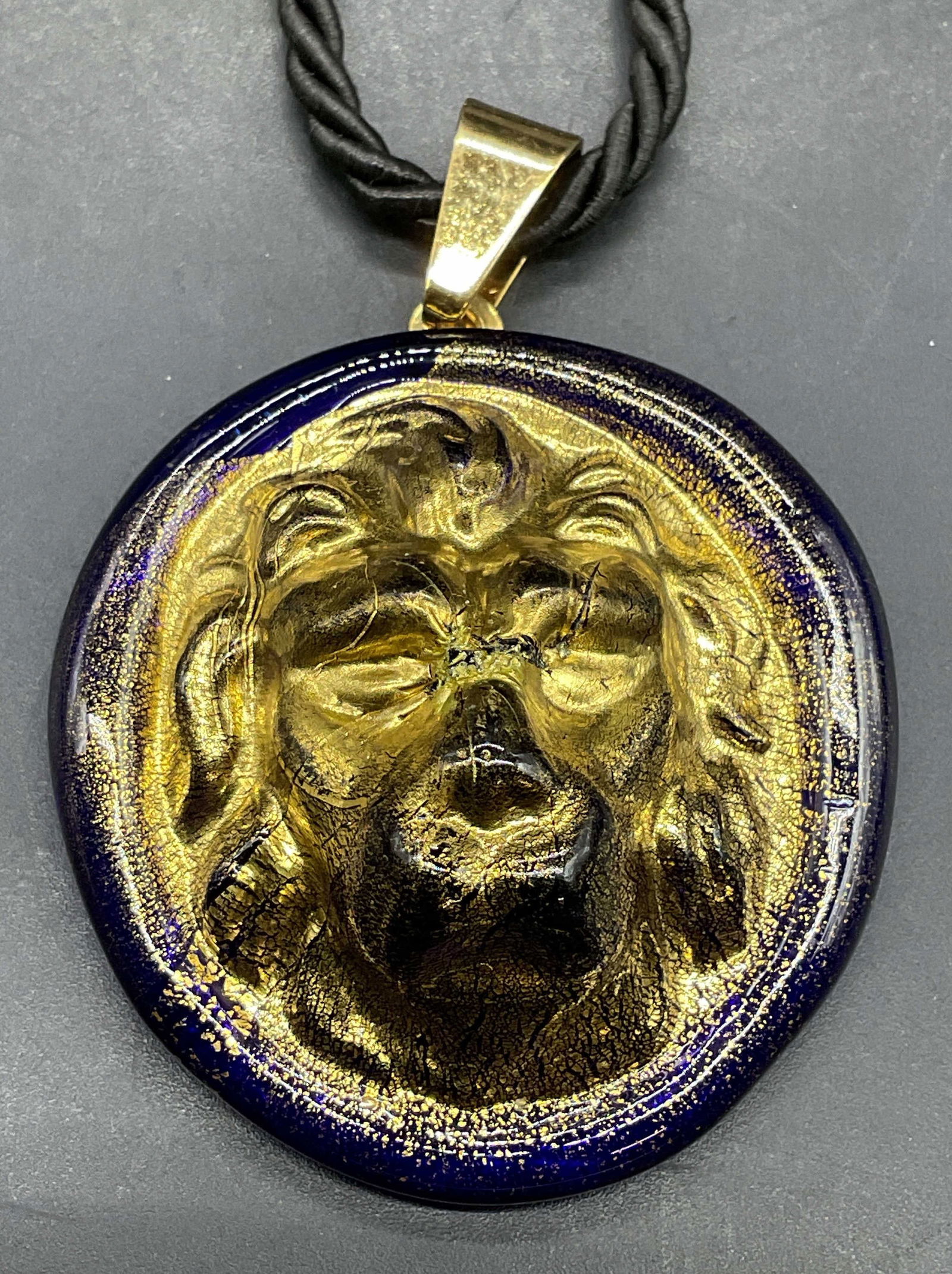 MURANO Gilt Art Glass Lion Necklace, Italy: Signed MURANO cobalt blue and gilt art glass lion pendant necklace on black cord. Made in Italy. Drop length approx 8.5 inches. Pendant approx 1.5 inches long. Some scratching. Jewelry, estate jewelry