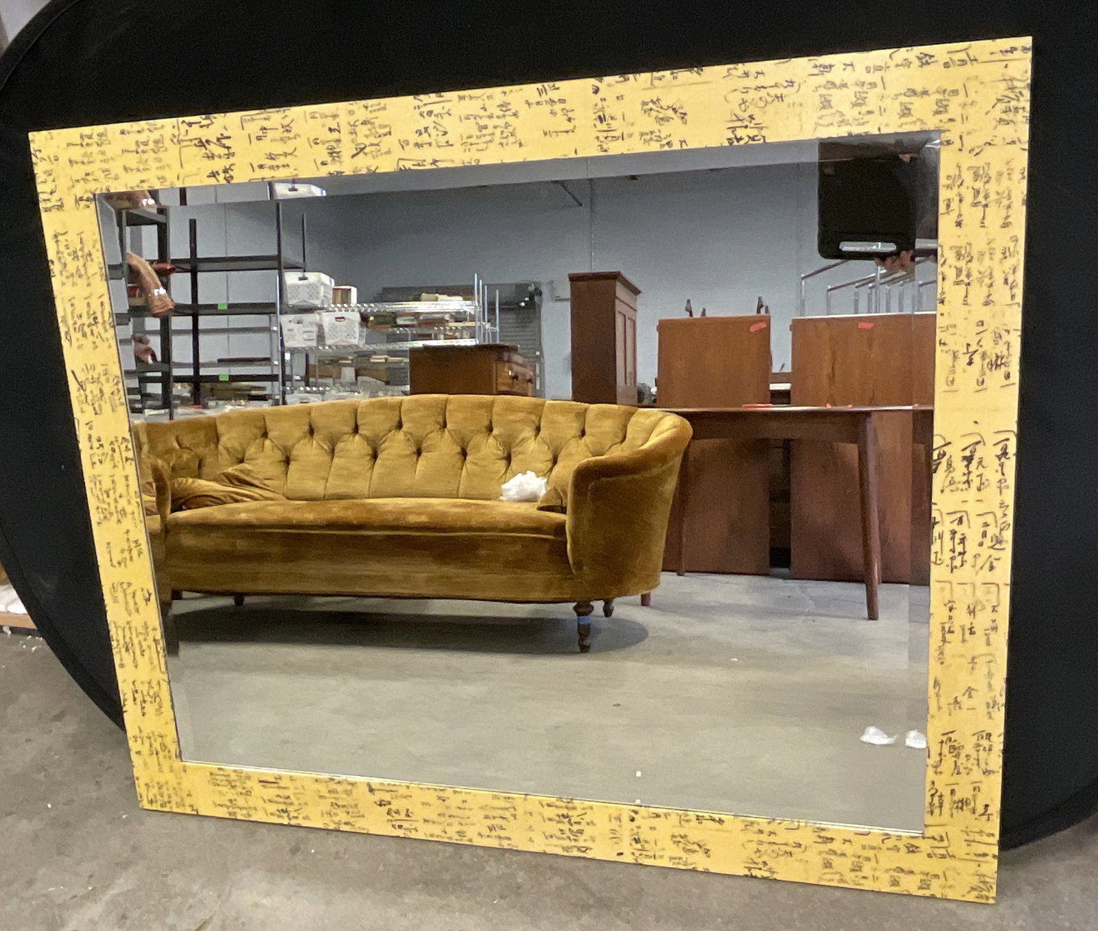 EXPRESSIONS CUSTOM FURNITURE Washi Script Mirror: EXPRESSIONS CUSTOM FURNITURE Washi Script Mirror. Crafted from wood. Black and yellow hues to the frame. Reverse reads EXPRESSIONS CUSTOM FURNIT Washi Script Mirror. Metal hardware to reverse. Measure