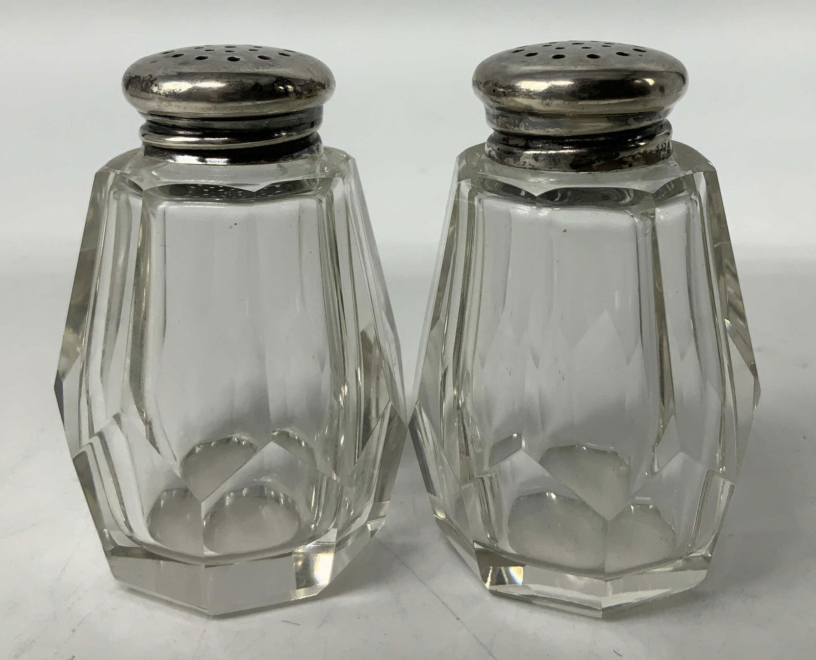 Vtg Pair HB 835 Crystal Salt & Pepper Shakers: Lot includes, pair of crystal salt & pepper shakers. Shakers body feature a faceted design & 835 HB on tops. Surface wear consistent to age, use & exposure. Measurements: length 1.5in x width 1.5in x