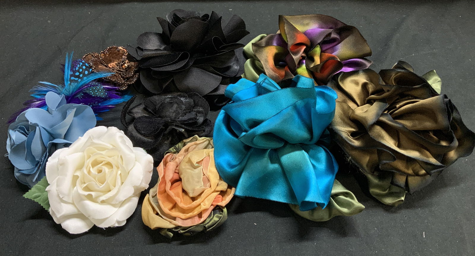 Assorted Floral Fabric & Feather Pins: Lot includes, 10 assorted floral fabric & faux feather pins. Vary in size & shade. Signed & marked. Reads, BEVERLY GAYLE. Surface wear consistent to age, use & exposure. Measurements: length 6.2in x w