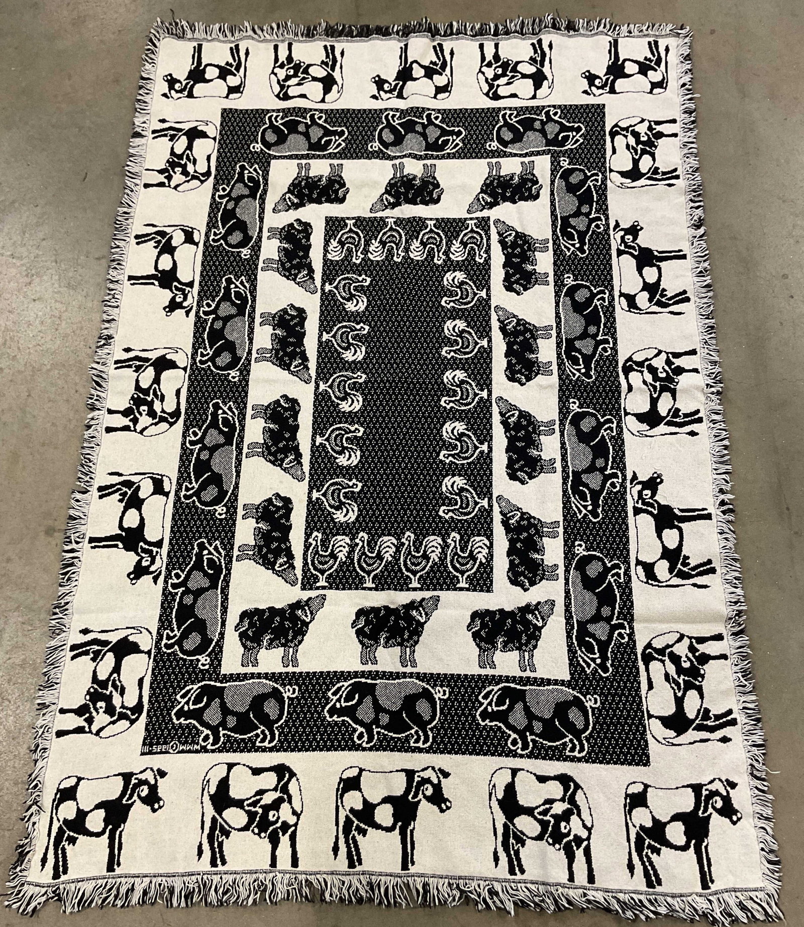 Vintage Black & White Animal Fringed Blanket: Vintage black and white animal figural fringed blanket. Signed, reads illegibly. Feels knitted. Black and white fringed trim. Repeating animal motifs include chicken, pig, sheep, and cow. Abstract dot