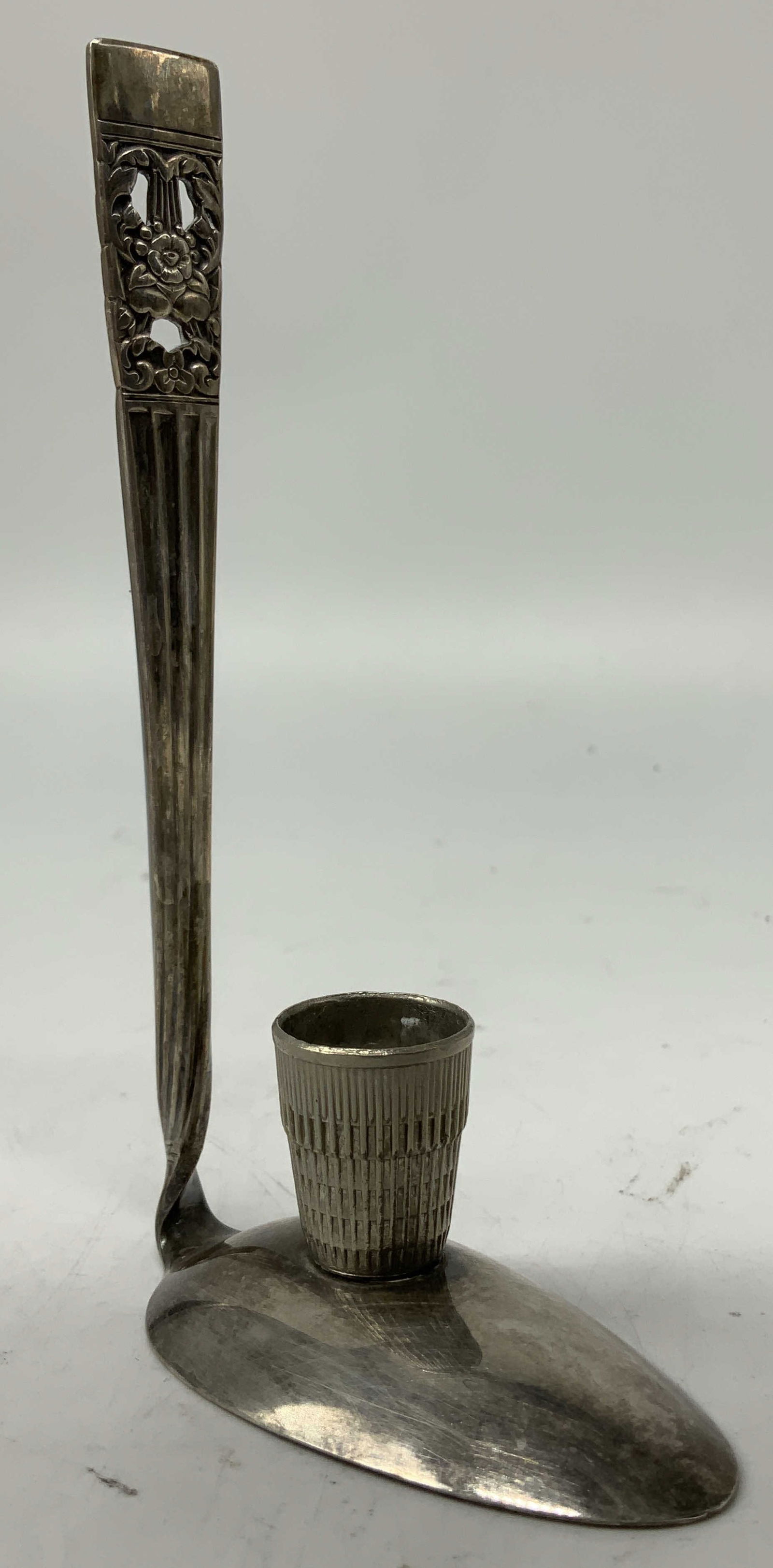 Vtg Oneida Silver Toned Spoon Chamberstick USA: Piece is hand-made & features a spoon w an ornate handle upcycled into a chamberstick. Silver toned metal. Signed & marked. Reads, ONEIDA USA. Surface wear consistent to age, use & exposure. Measureme