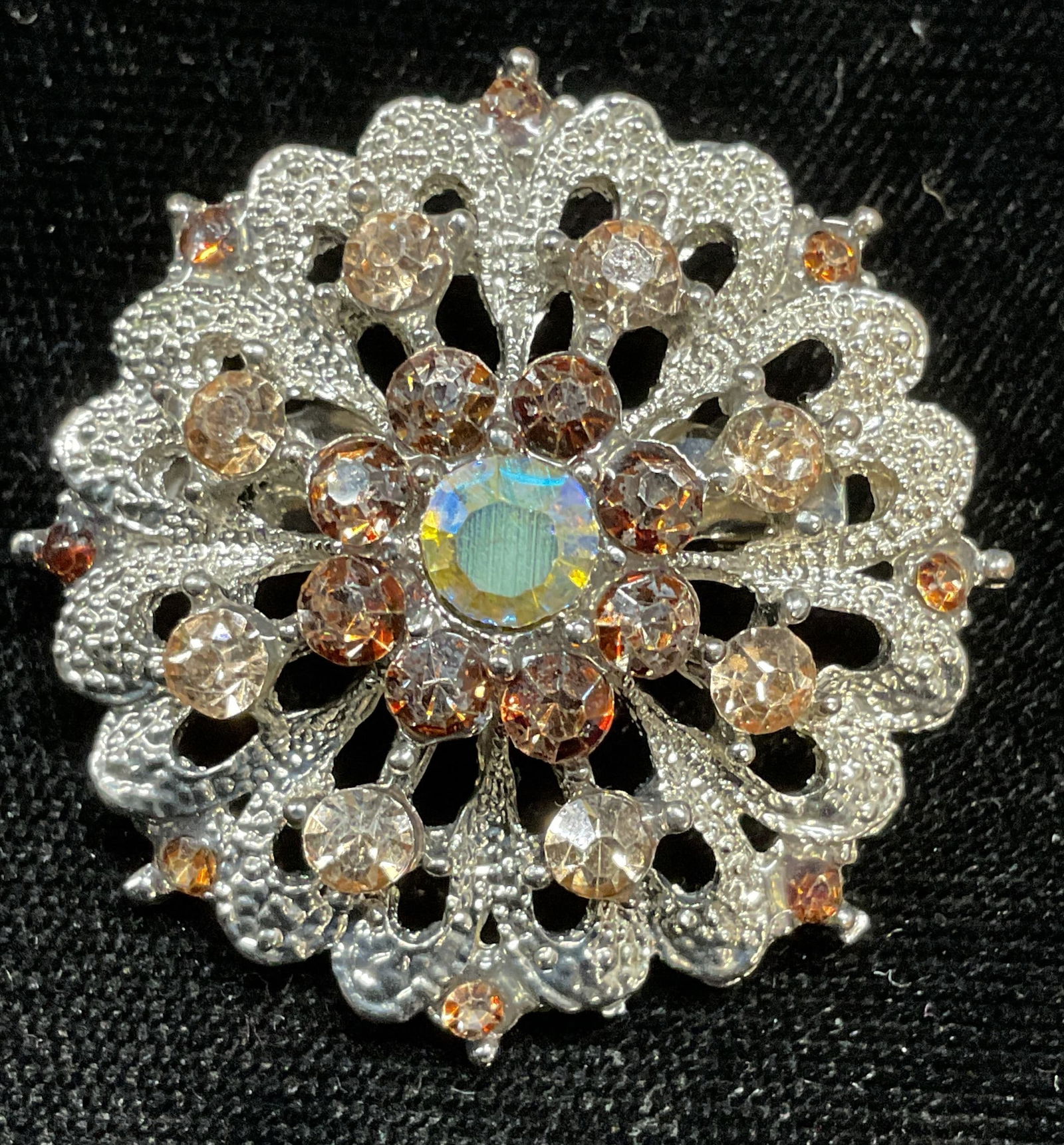 Vintage Silver Crystal Flower Brooch: Vintage silver tone flower brooch with multicolor crystals. Measures approx 1.25 inches wide. Some scratching. Jewelry, estate jewelry, costume jewelry, cocktail jewelry, fashion jewelry, accessories,
