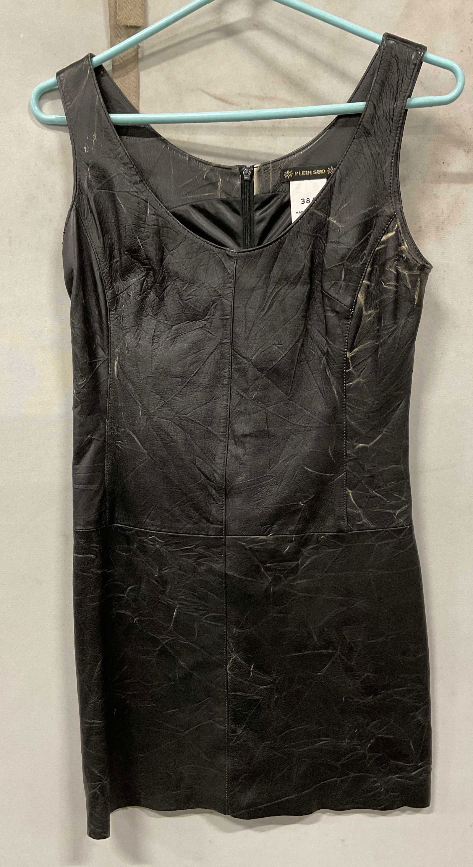 Plein Sud Black Leather Dress France: Plein Sud black leather sleeveless dress. Made in France. Size 6. Leather material. Zipper on the back. Wear to leather consistent with exposure. Property of 1980s known Rockers Manhattan estate. Dres