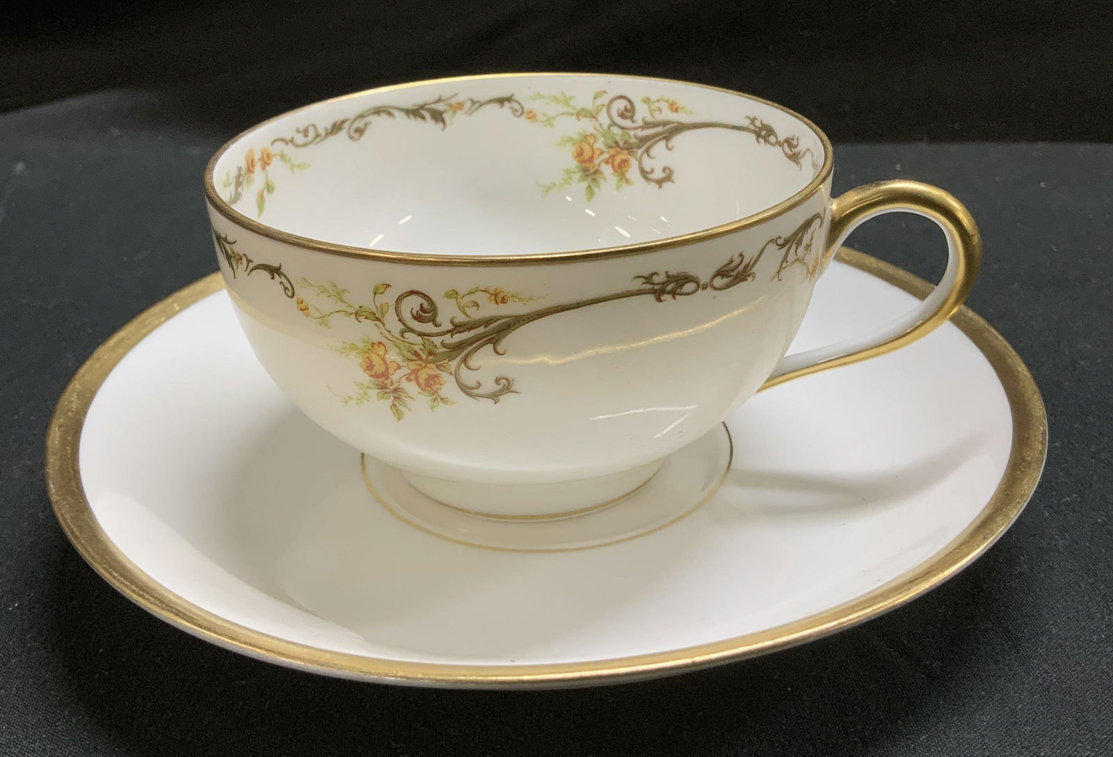 Haviland & Co. Limoges Floral Teacup & Saucer: Lot includes, 1 teacup & 1 saucer. Pieces are porcelain & feature gilt accents on rim/handle. Yellow floral detailing. Signed & marked on underside. Reads, HAVILAND FRANCE. HAVILAND & CO. LIMOGES 3211