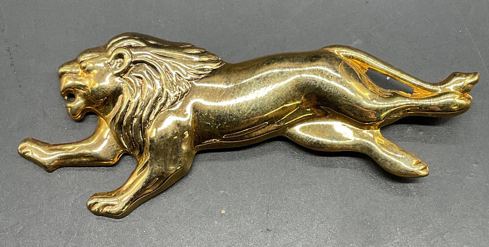 Gold Tone Lion Brooch 3.5 In Long: Gold tone Lion motif brooch. Measures approx 3.5 x 1.25 inches. Some scratching. Jewelry, estate jewelry, costume jewelry, cocktail jewelry, fashion jewelry, accessories, fashion accessories, wearable