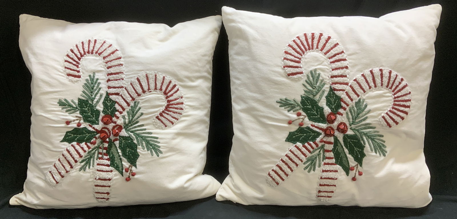 Pr Pottery Barn Candy Cane Throw Pillows PAKISTAN: Lot includes, pair of Pottery Barn candy cane embroidered throw pillows. Feature red bell accents. 100% cotton. Signed & marked. Reads, POTTERY BARN. MADE IN PAKISTAN. Measurements: length 20in x widt