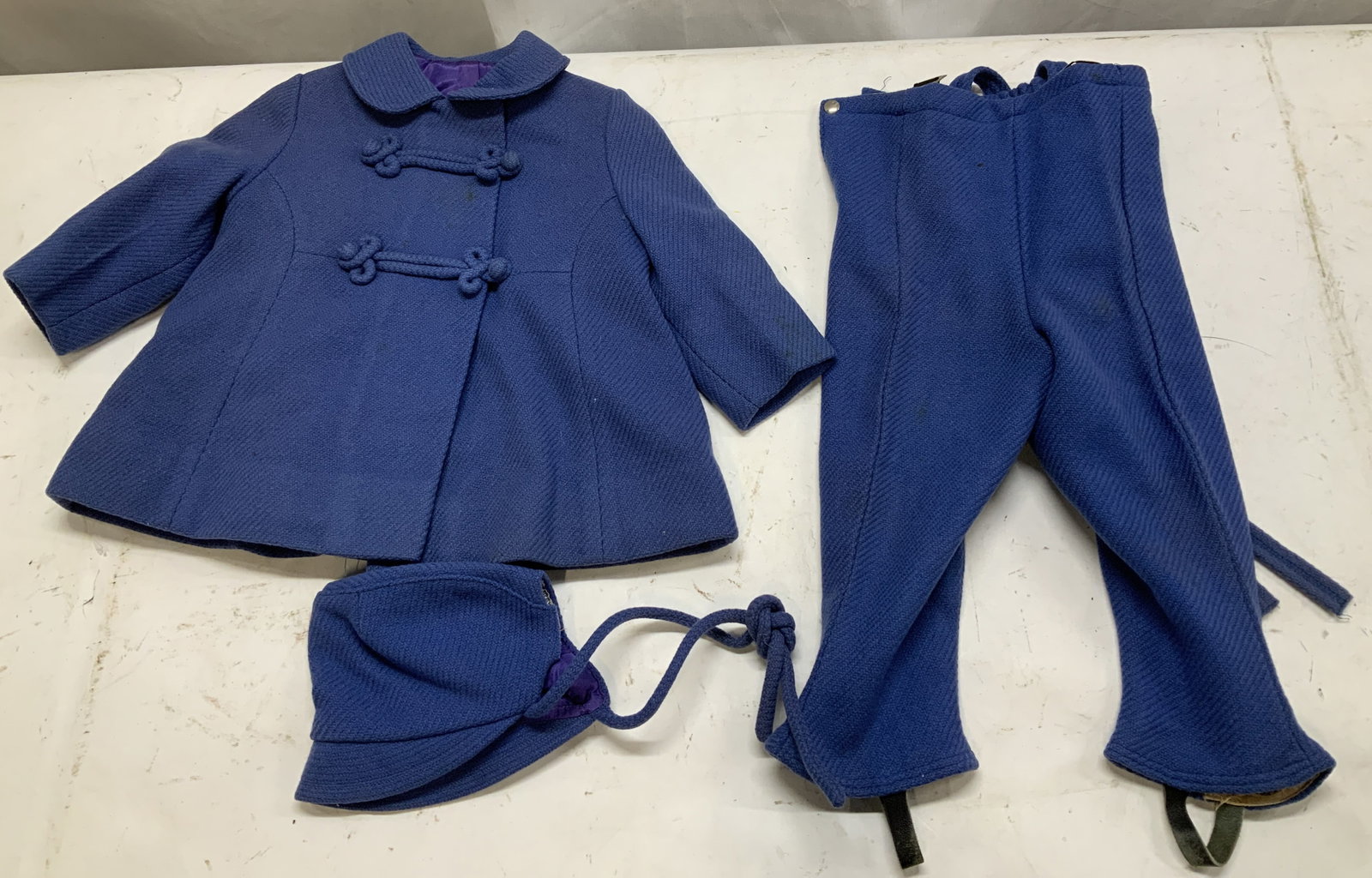 Vtg Liliputian Bazaar Best & Co. 3 Piece Outfit: Vintage 3 piece outfit consisting of a short sleeve jacket, matching trousers & bonnet. Pieces are blue toned. Trousers have a side zipper closure. Signed & marked. Reads, LILIPUTIAN BAZAAR. TRADEMARK