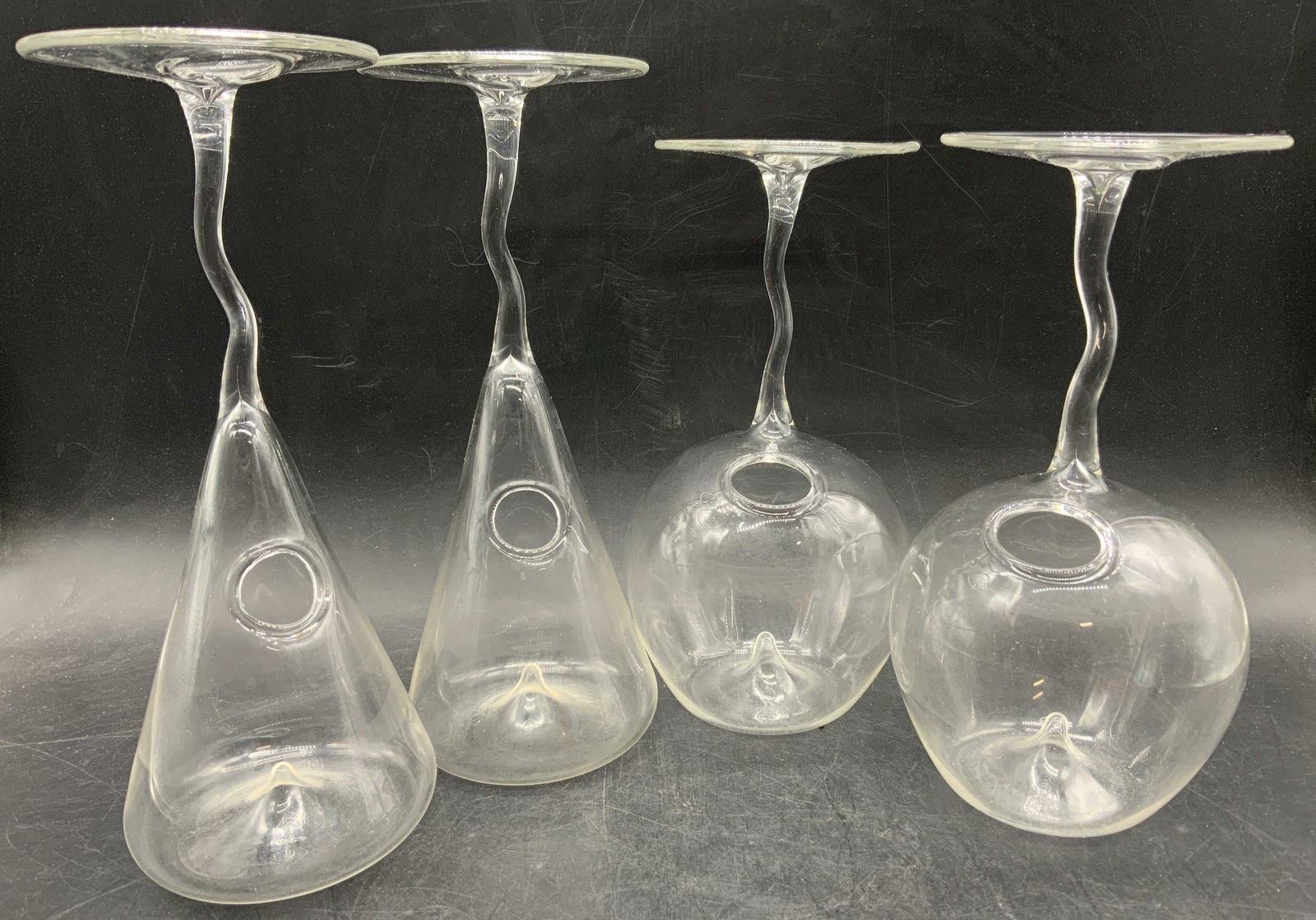 Lot4 Vintage Specialty Upside Down Cocktail Glasses: Lot of 4 vintage art glass drinking cocktail glasses. Thin and wavy stems. Circular bases with circular indentations / drip design. Openings for straw in base and body. Rounded and cylinder shapes. La
