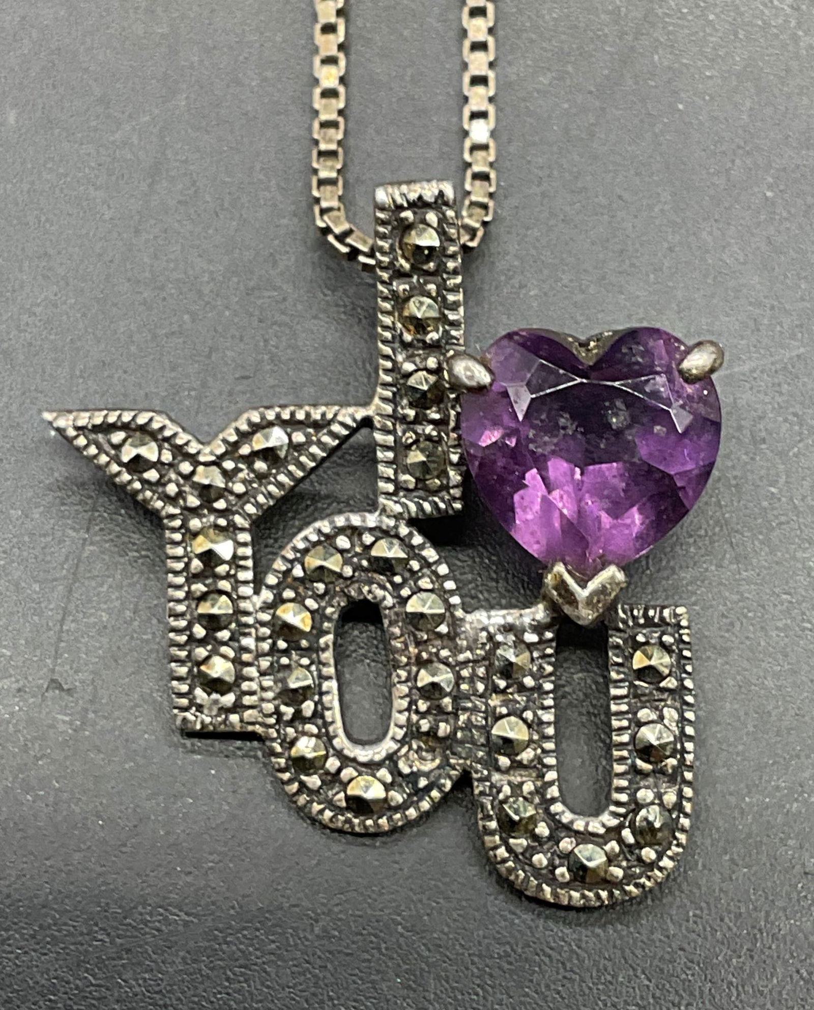 Sterling Silver I love You Pendant Necklace: Vintage sterling silver necklace with sterling silver I Love You motif pendant with purple crystal. Necklace made in Italy. Drop length approx 9.75 inches. Total weight 5.4 grams. Some scratching. Jew