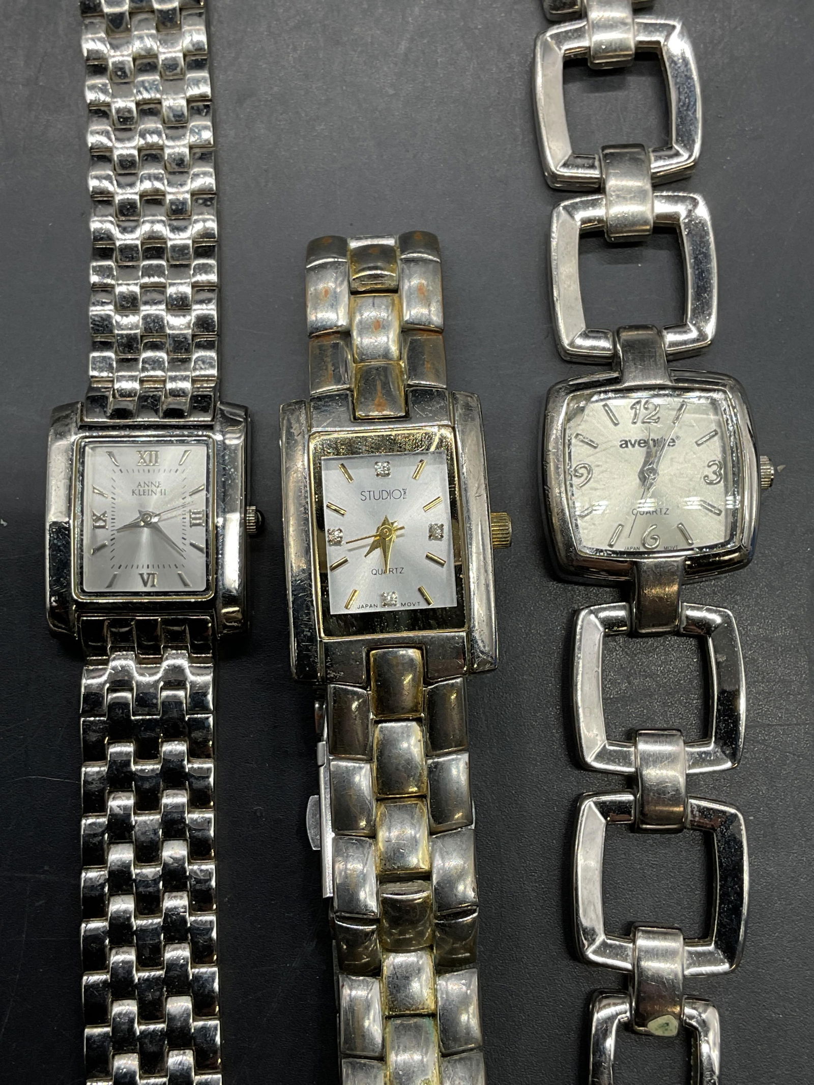 Lot 3 Anne Klein, Avenue, Studio Time Watches: Lot of 3 signed Anne Klein II, Avenue, and Studio Time silver tone wristwatches. Longest approx 7.75 inches long. Not tested. Some scratching. Jewelry, estate jewelry, costume jewelry, cocktail jewelr